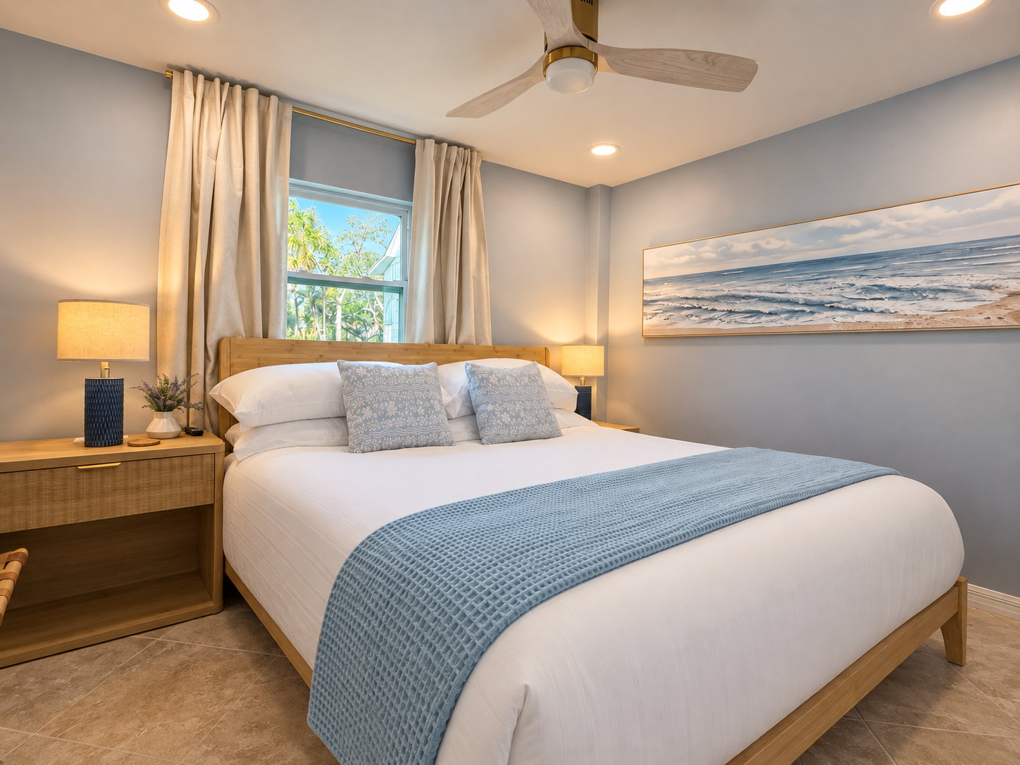 Bright coastal bedroom with plush linens, natural light, and serene style