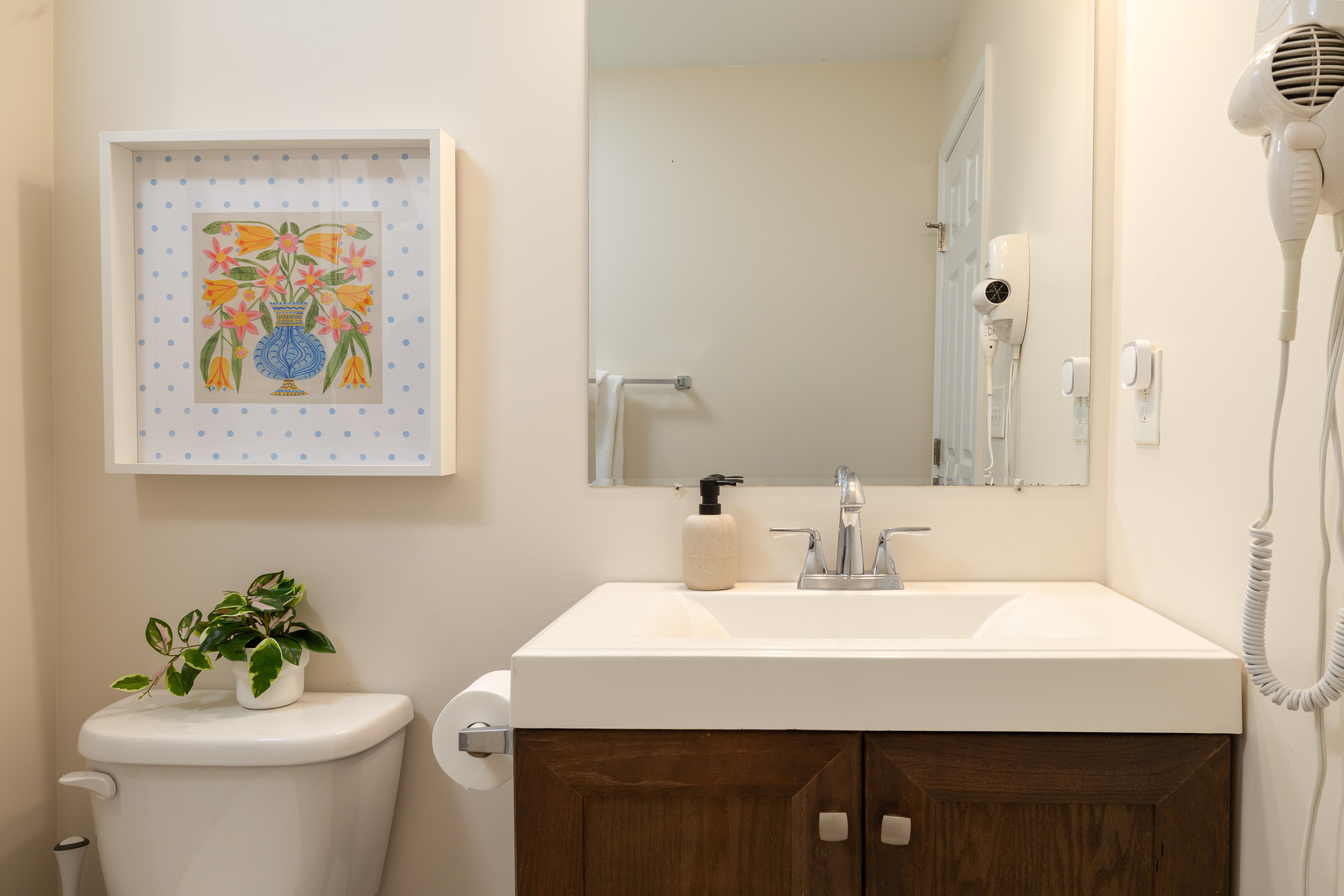 Second bathroom vanity with a wall-mounted hair dryer
