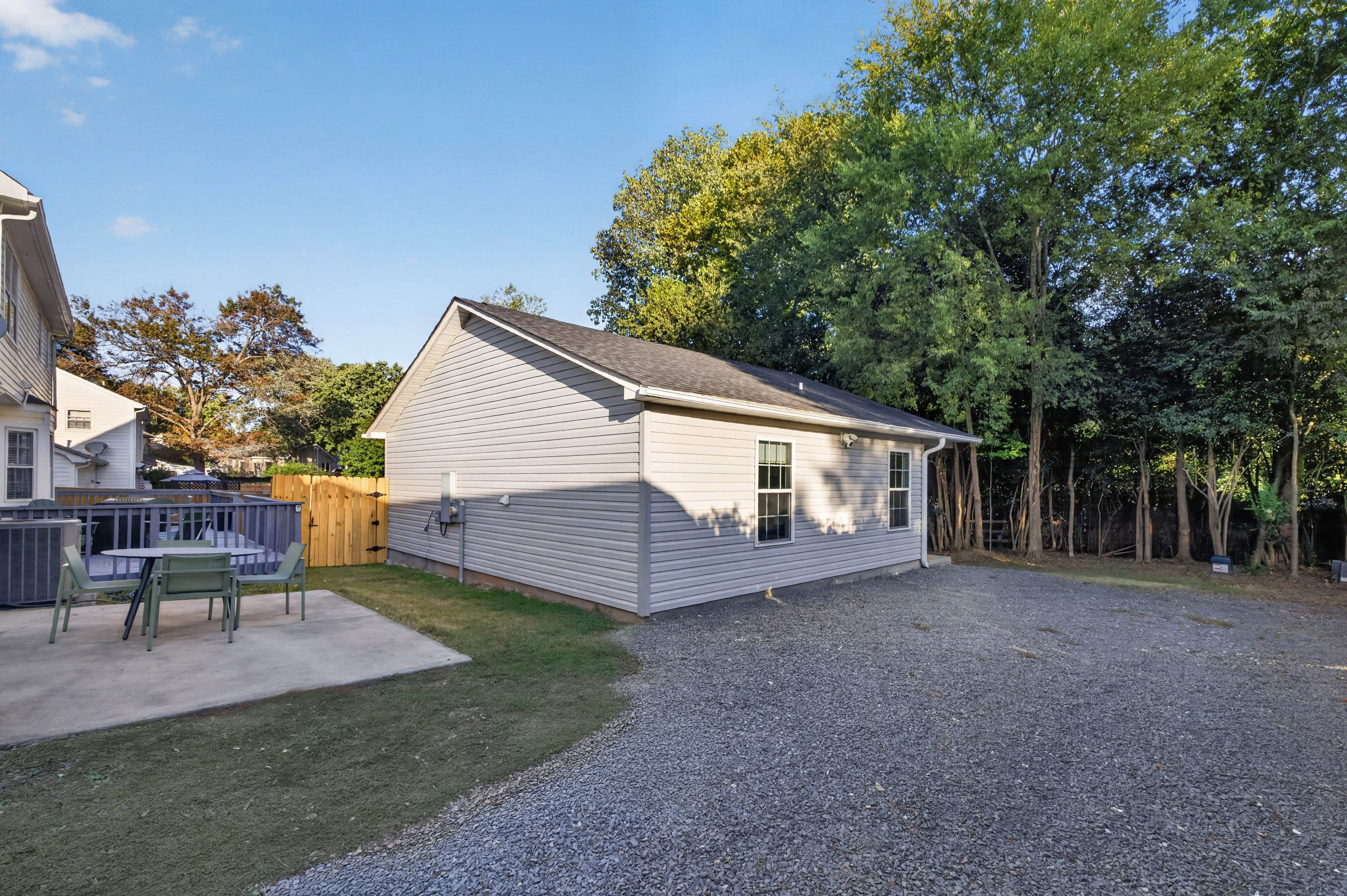 The Garden House and its patio, with parking on the gravel drive
