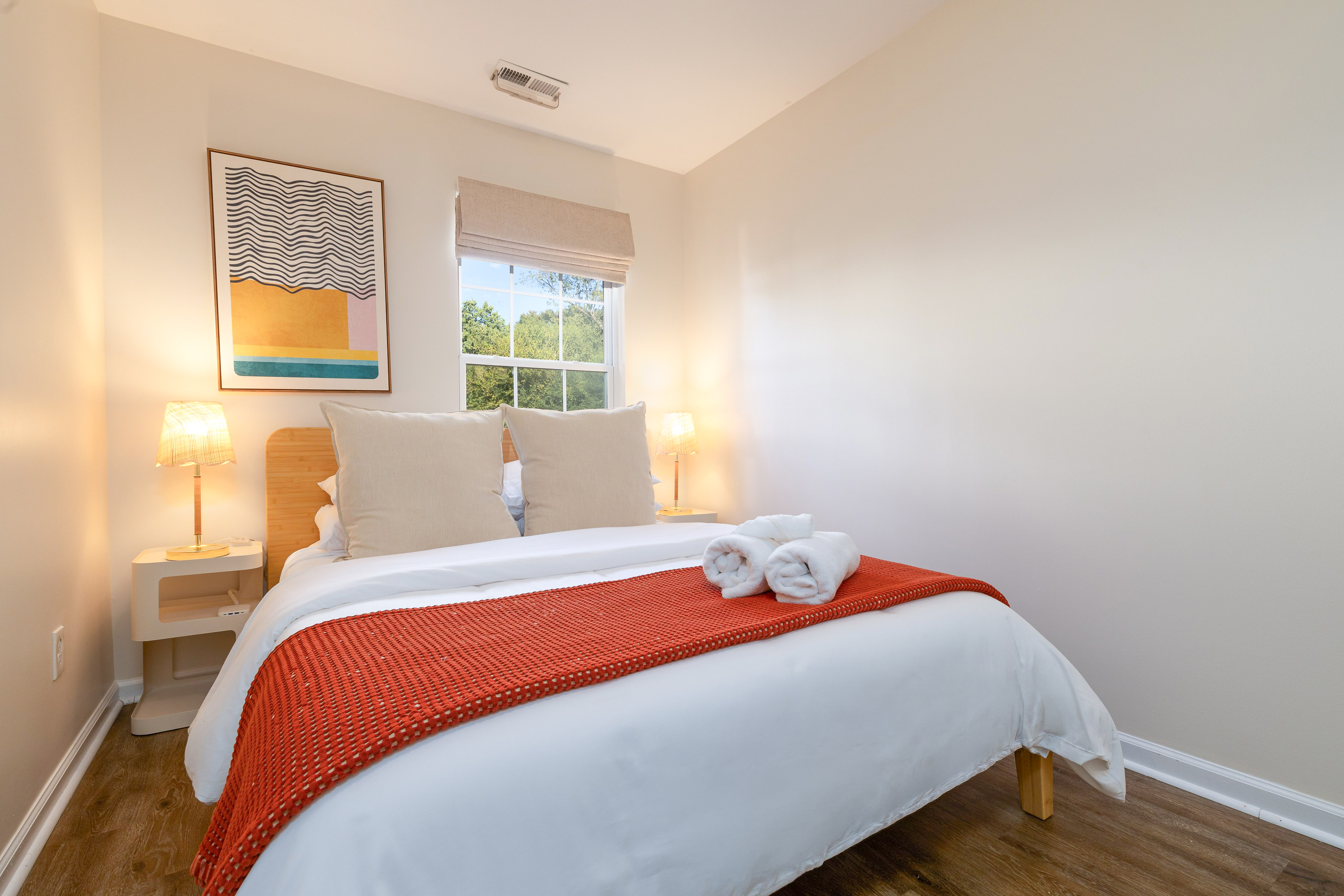 Bedroom 3: queen bed, two nightstands and a blackout roman shade