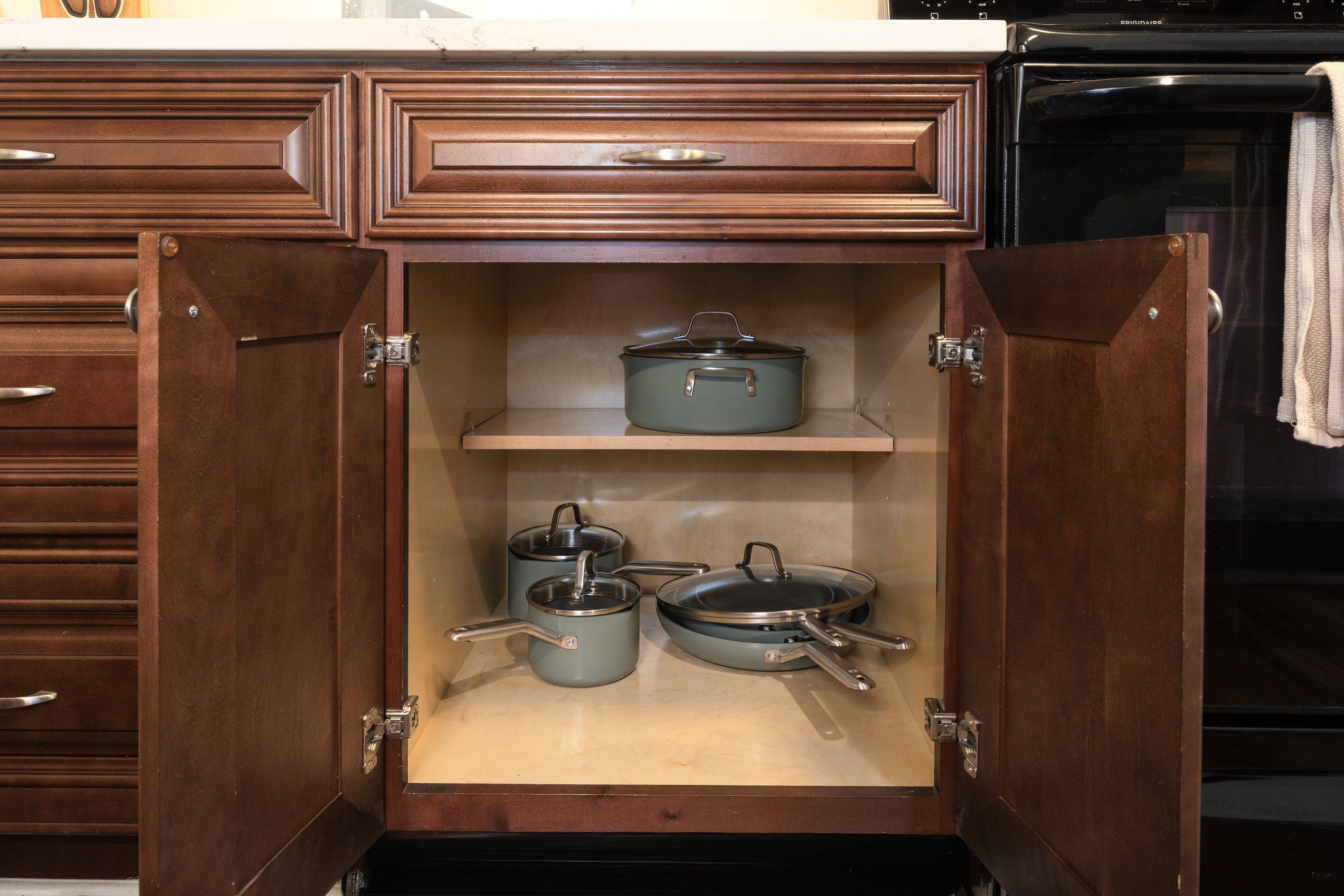 Pots and pans in the cabinet under the counter