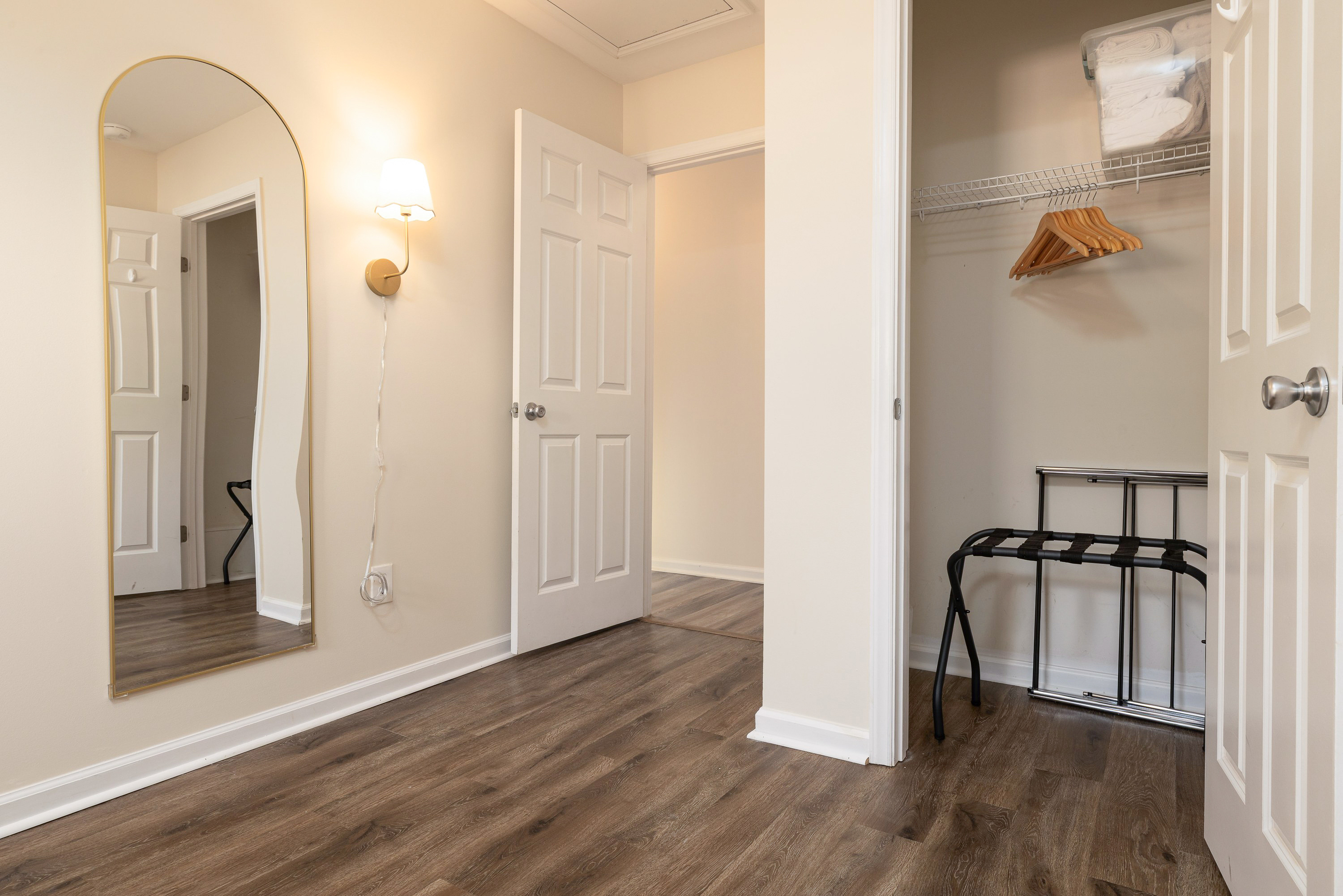 Bedroom 3 closet with hangers and a luggage rack, plus an arched full-length mirror