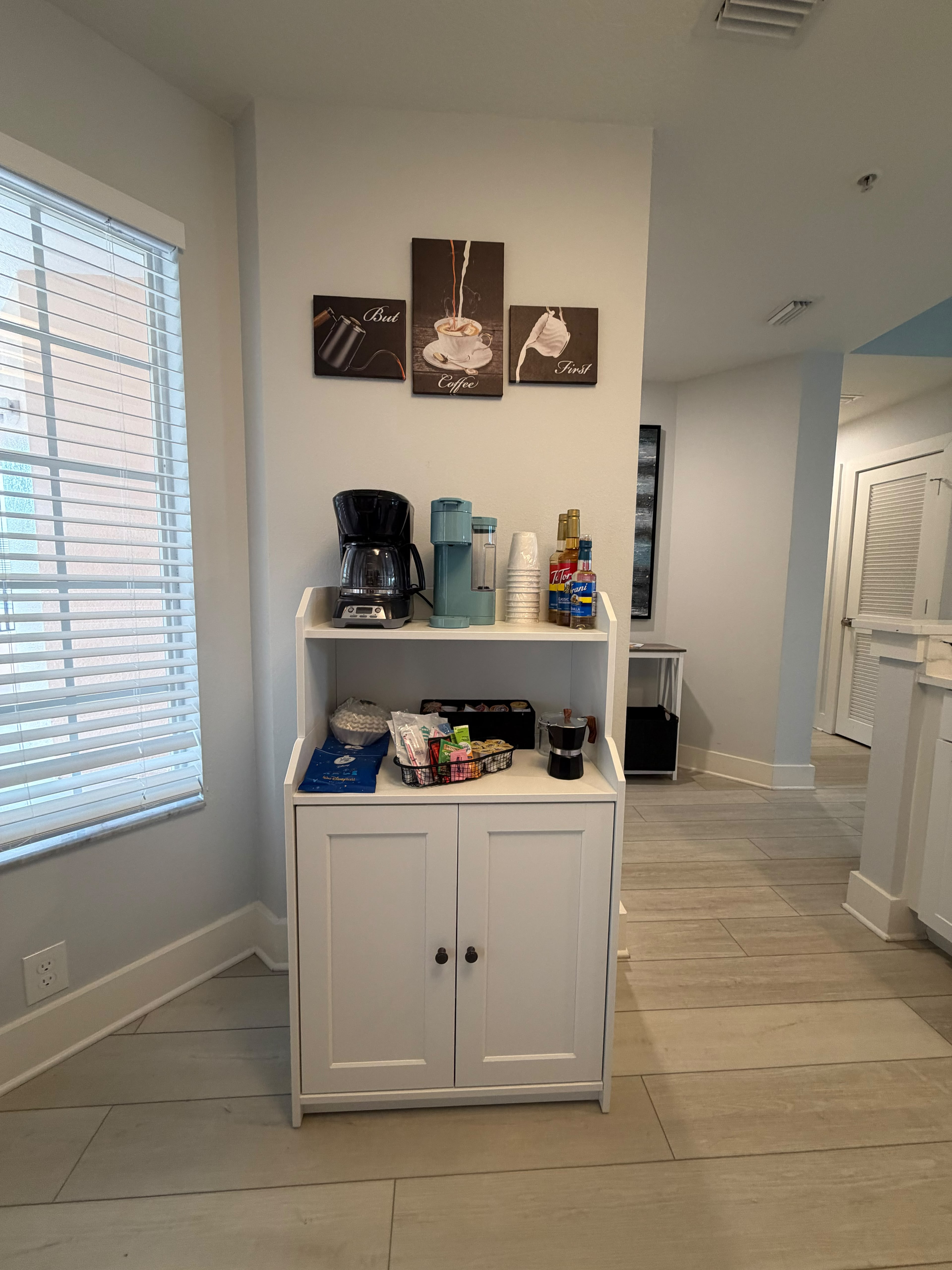 Bright guest coffee station with stocked essentials and modern style