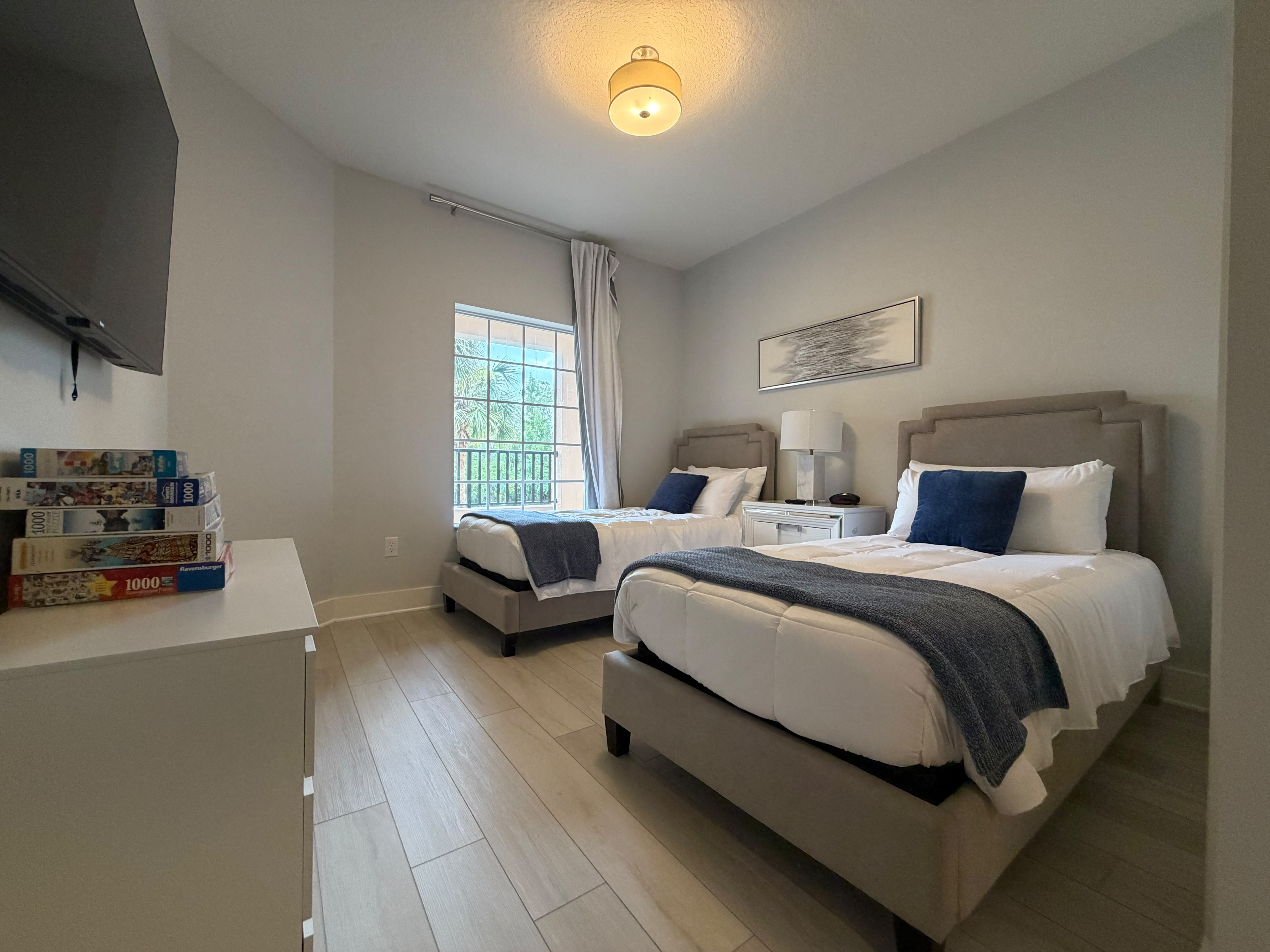 Bright double bedroom with two comfy beds and calming modern decor