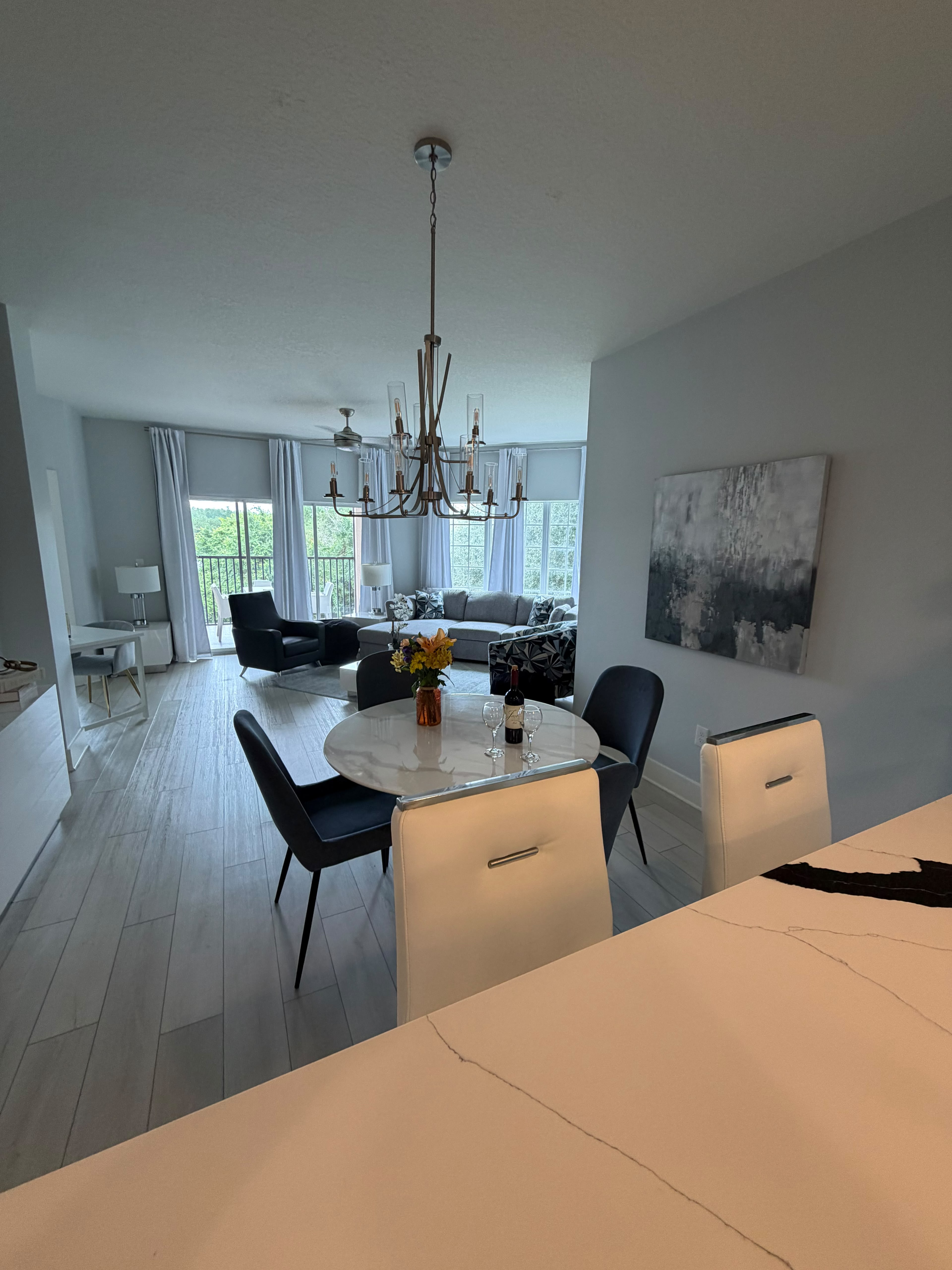 Bright open-concept living and dining space with balcony views