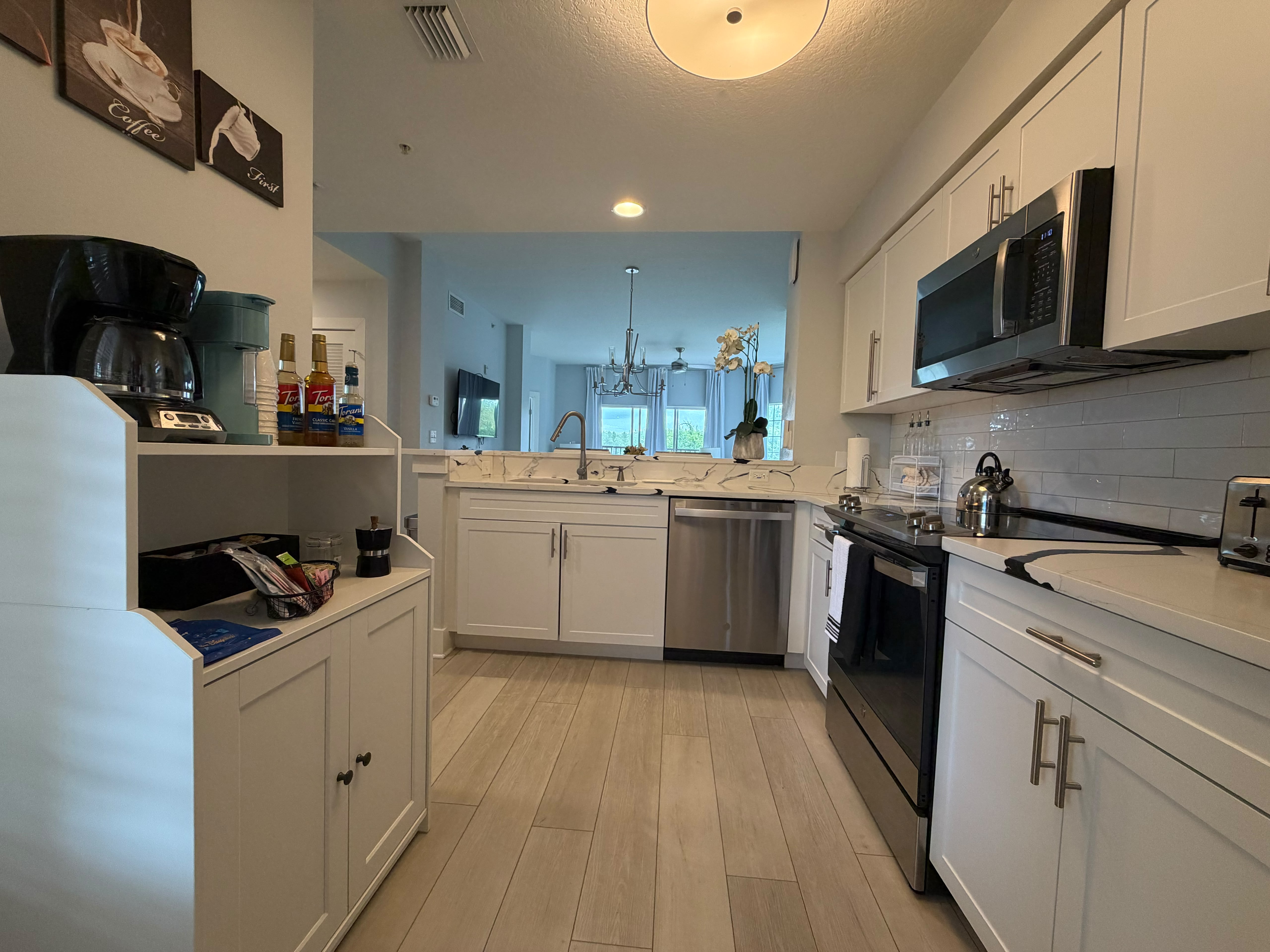 Bright modern kitchen with breakfast bar and stainless steel appliances