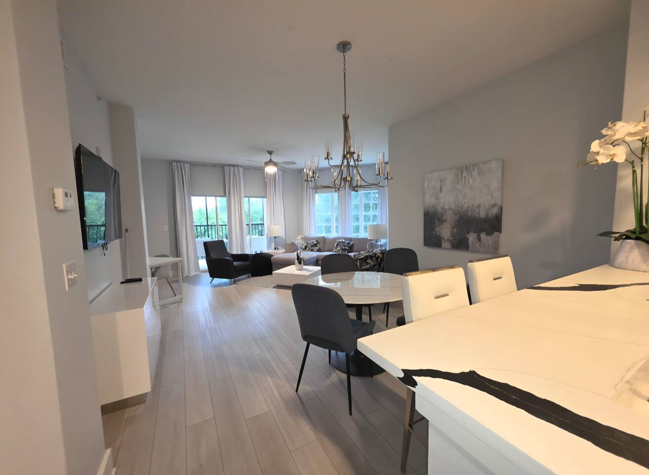 Bright open-concept living space with balcony and stylish modern decor