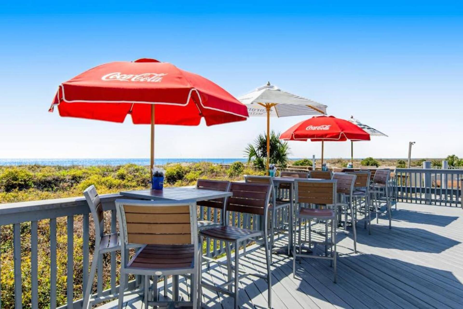 Sunny oceanview deck with shaded seating for relaxing outdoors