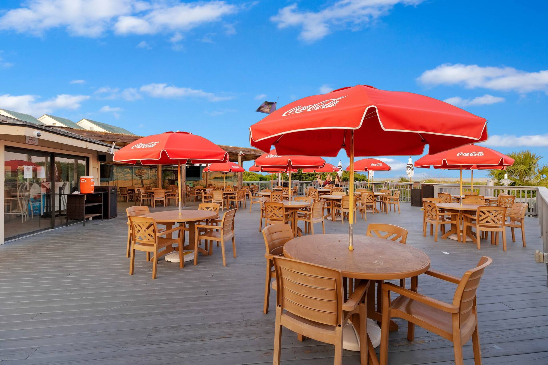 Spacious sun deck with umbrella-shaded outdoor dining seating