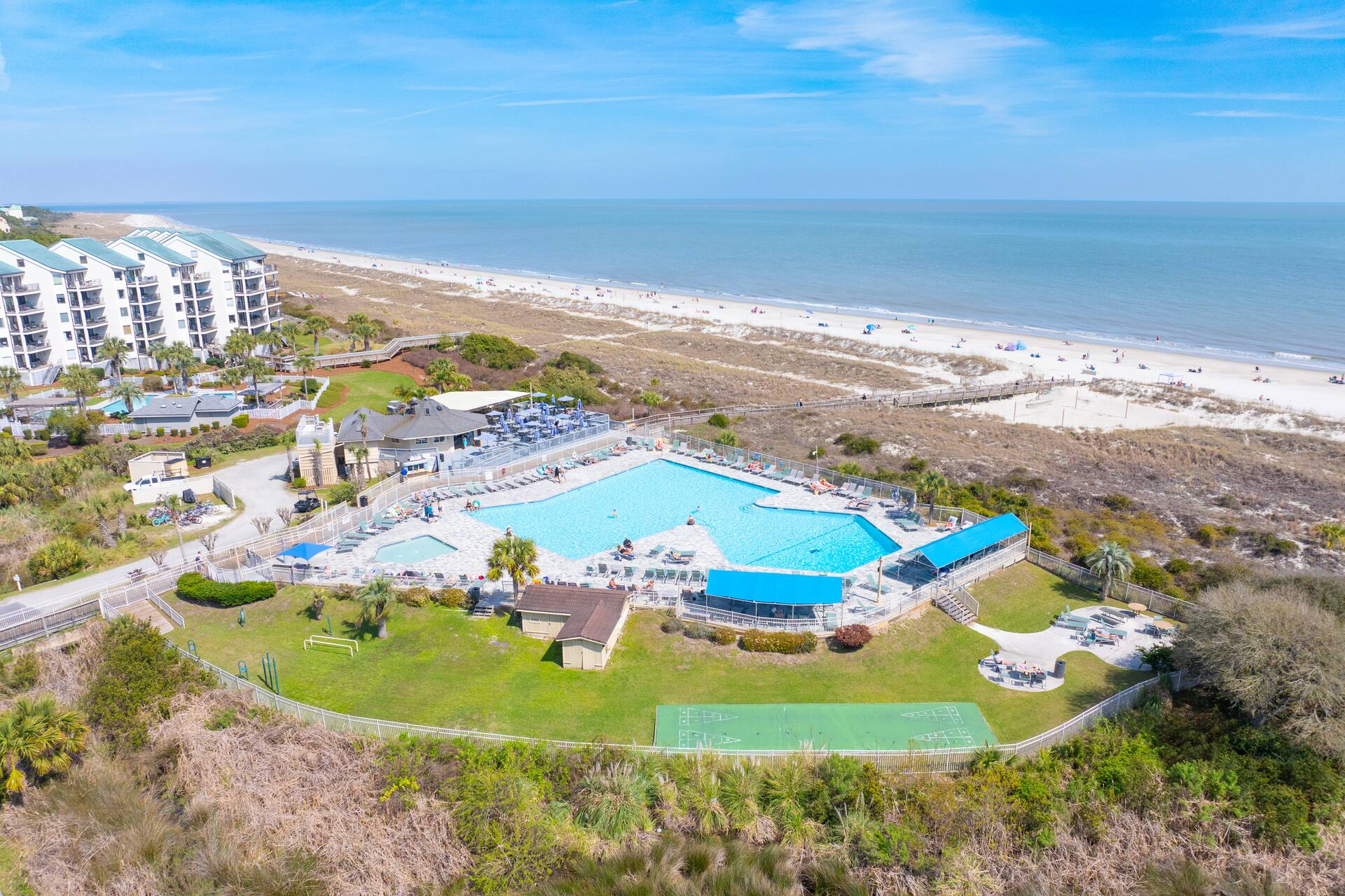 Beachfront resort with large pool, ocean views, and steps to the sand