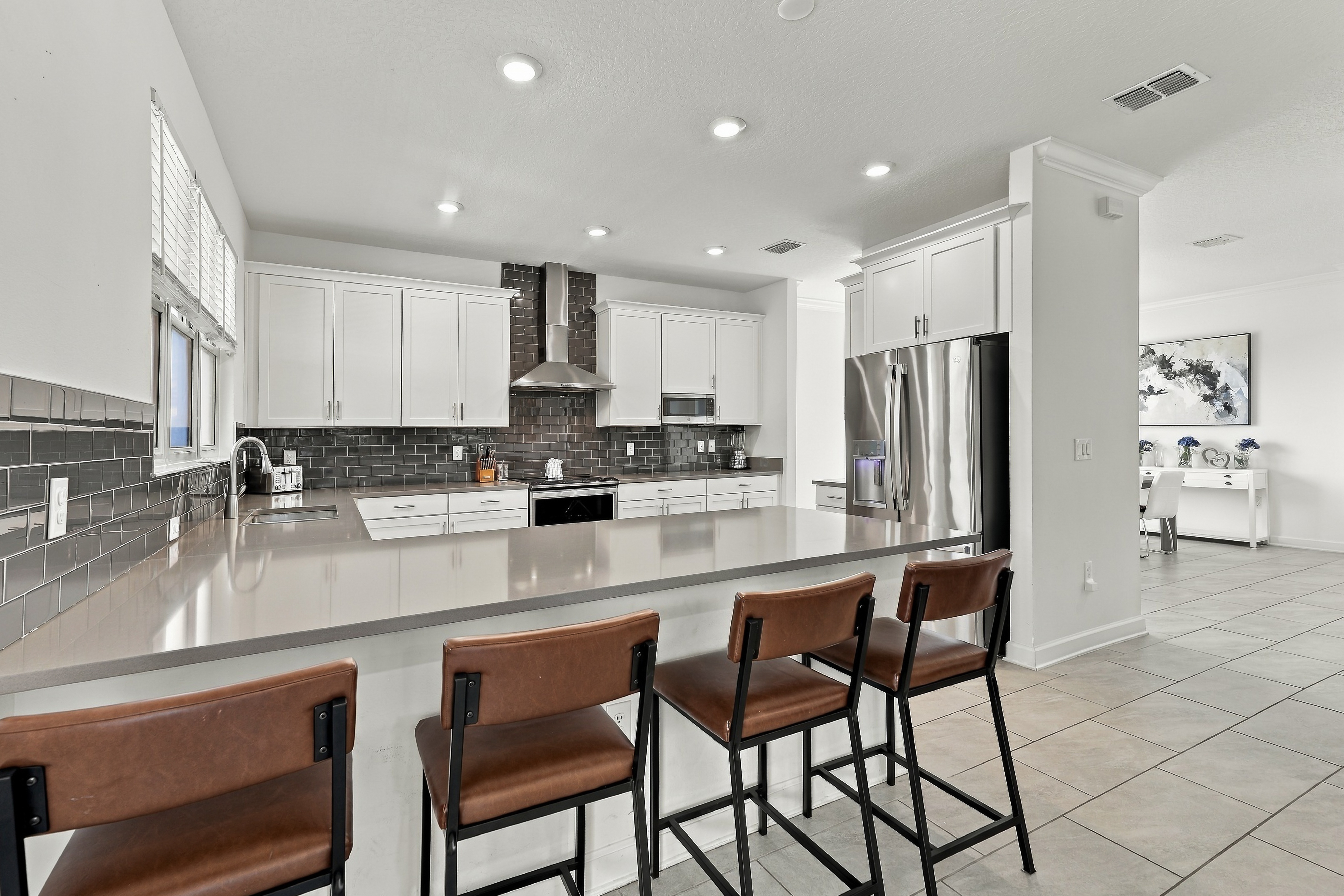 Bright modern kitchen with oversized breakfast bar and seating for four