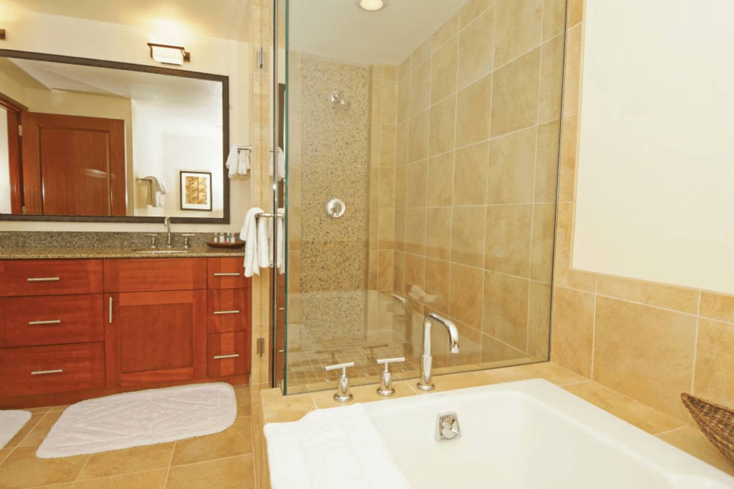 Spa-style bathroom with soaking tub, glass shower, and elegant vanity