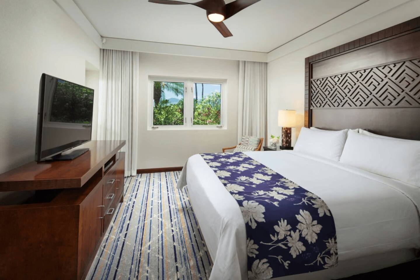 Bright tropical king bedroom with lush views and resort-style comfort