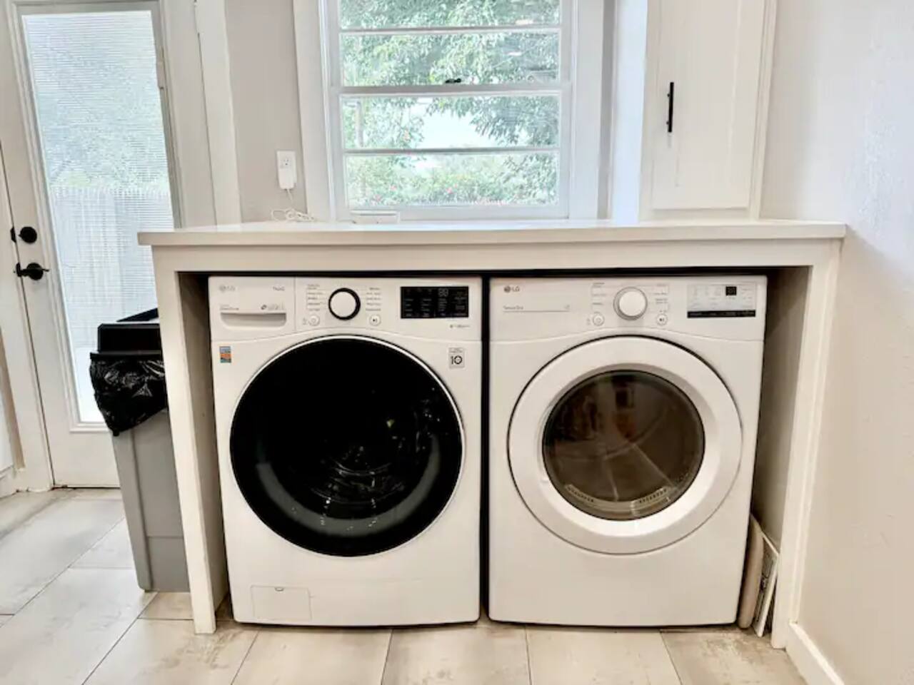 Enjoy the convenience of home with our modern laundry station! This sleek setup features a high-efficiency front-loading washer and dryer, plus a handy folding counter to make travel chores a total breeze.