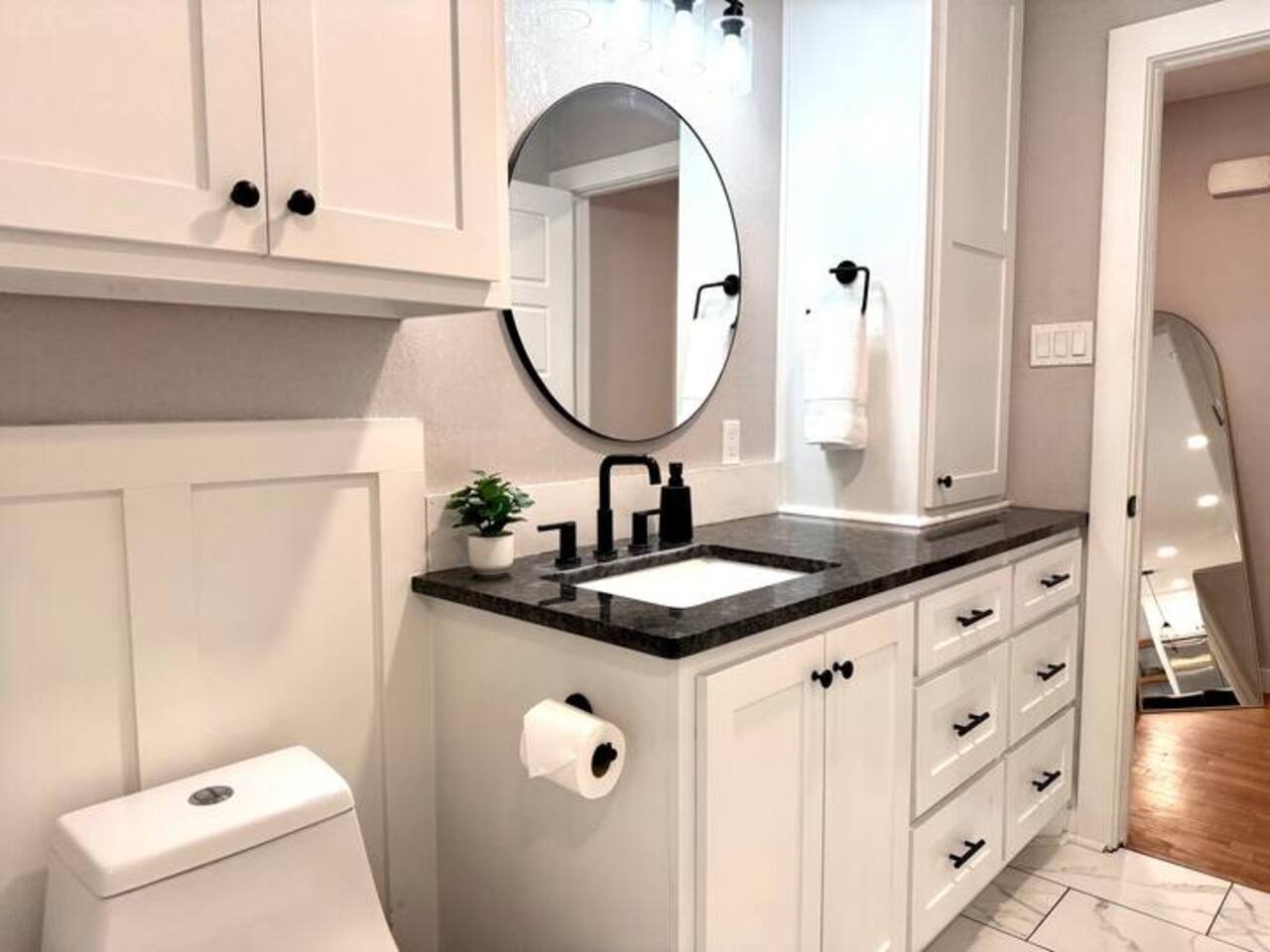 Experience modern luxury in this chic, renovated bathroom! Featuring a sleek marble-style countertop, crisp white cabinetry, and elegant black accents, it’s a bright and refreshing space designed for your ultimate comfort.