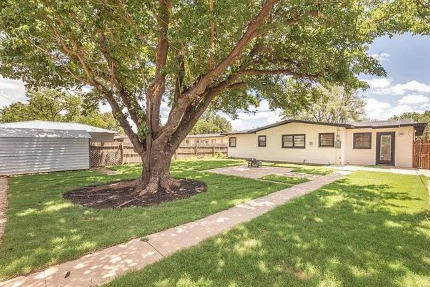Enjoy the private, spacious lawn, and the shade of a magnificent mature tree!