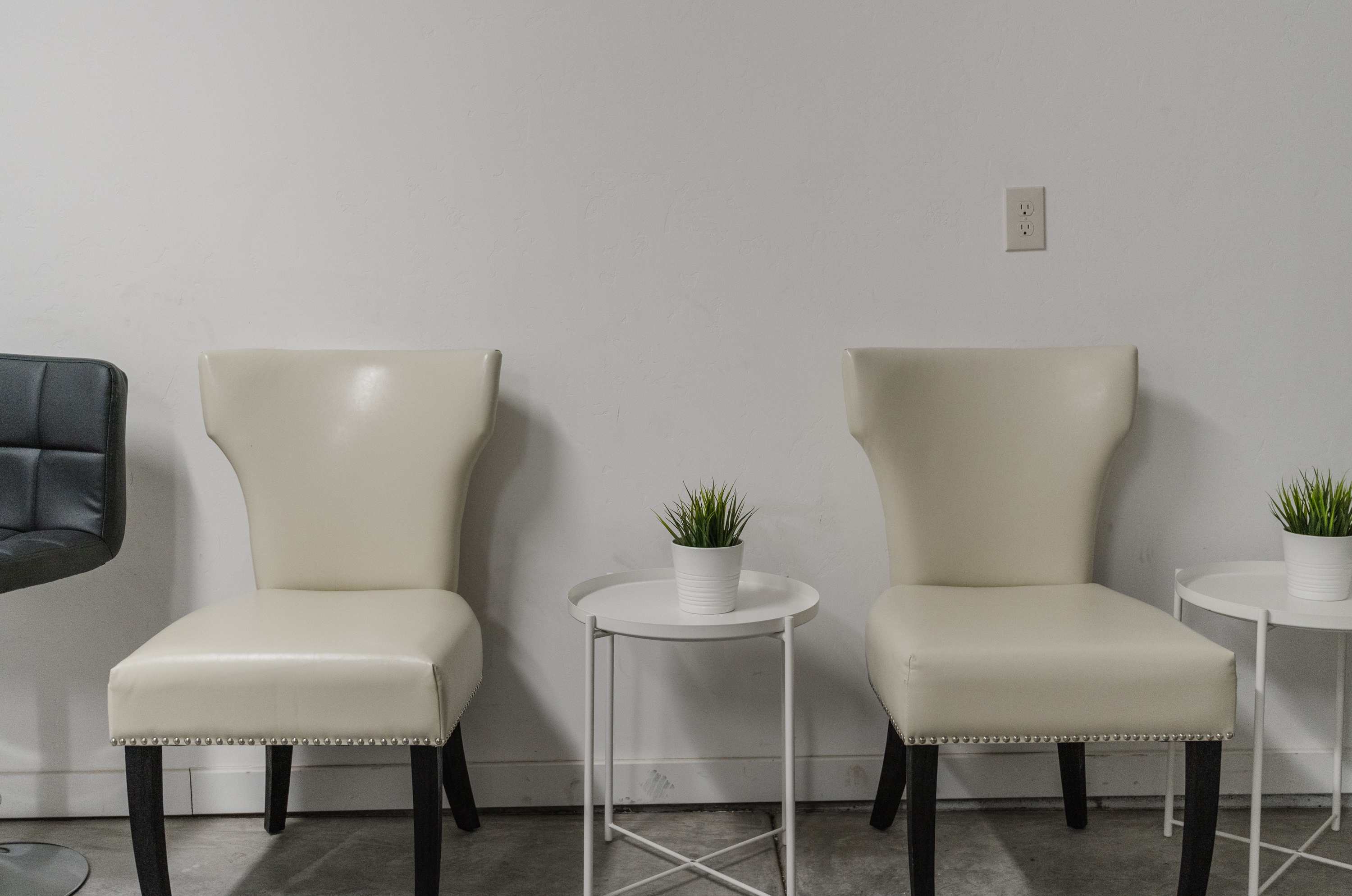 Bright, minimalist seating nook with accent chairs and side tables
