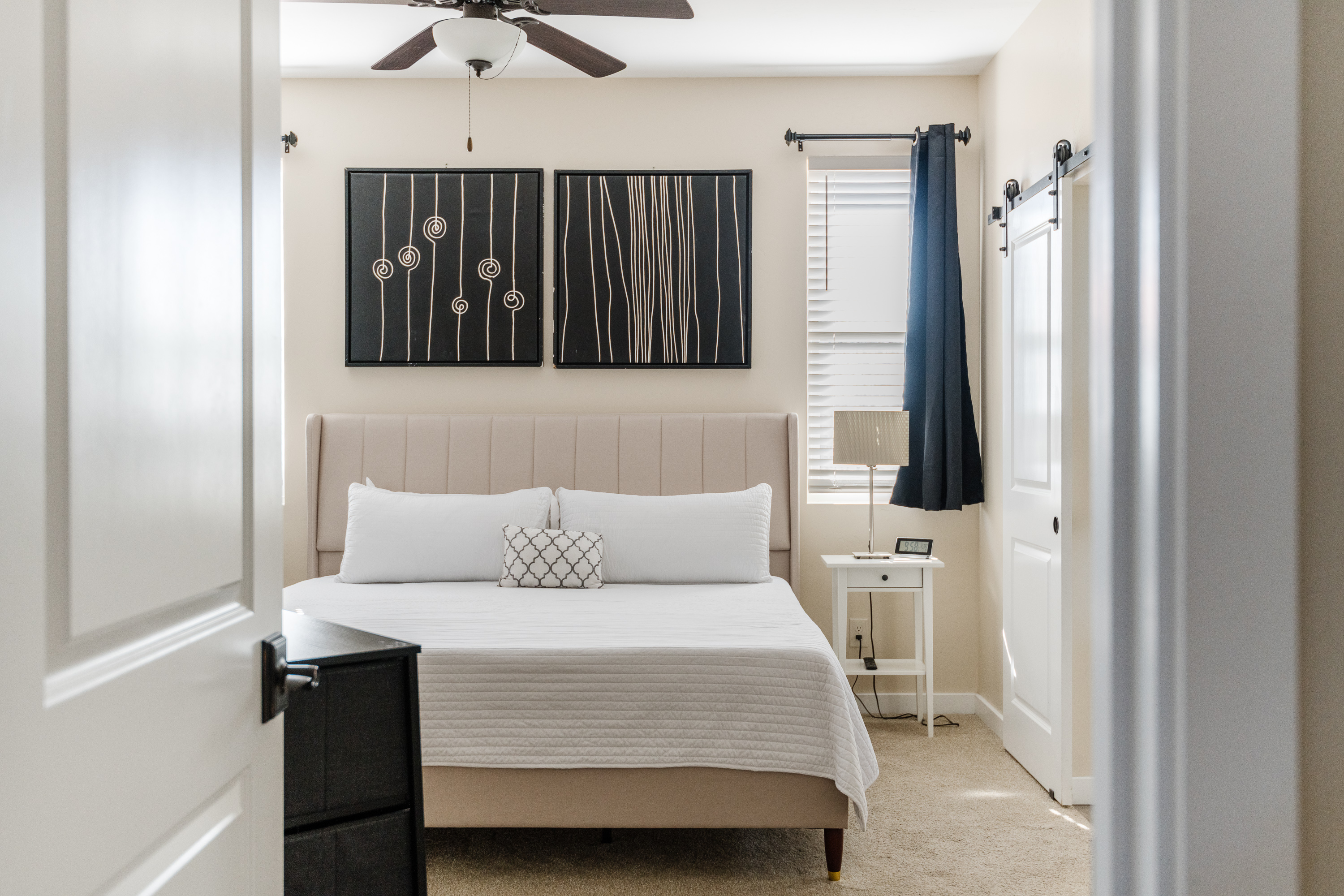 Bright, modern bedroom with plush bedding and stylish decor