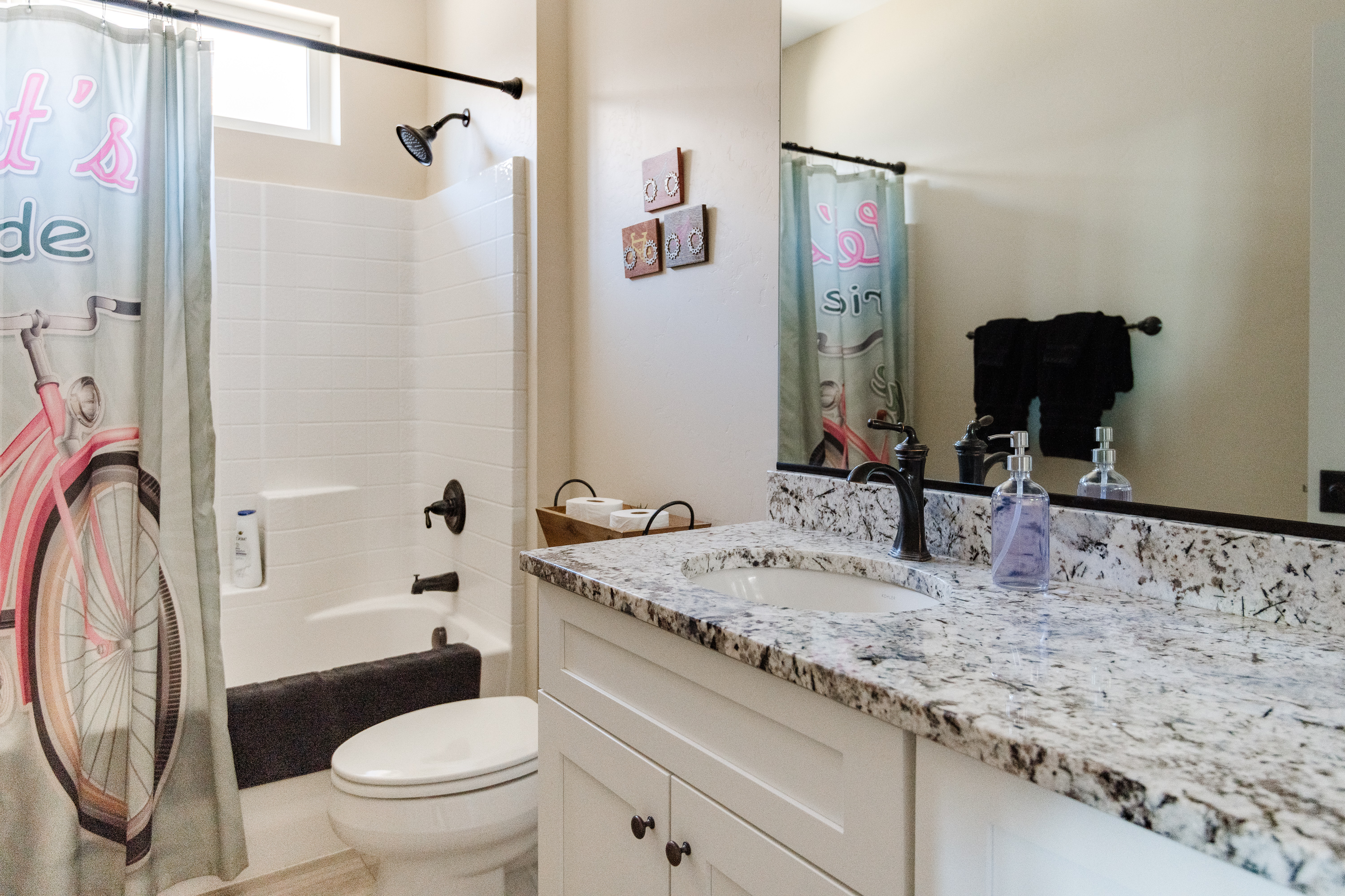 Bright modern bathroom with granite vanity and fun designer touches
