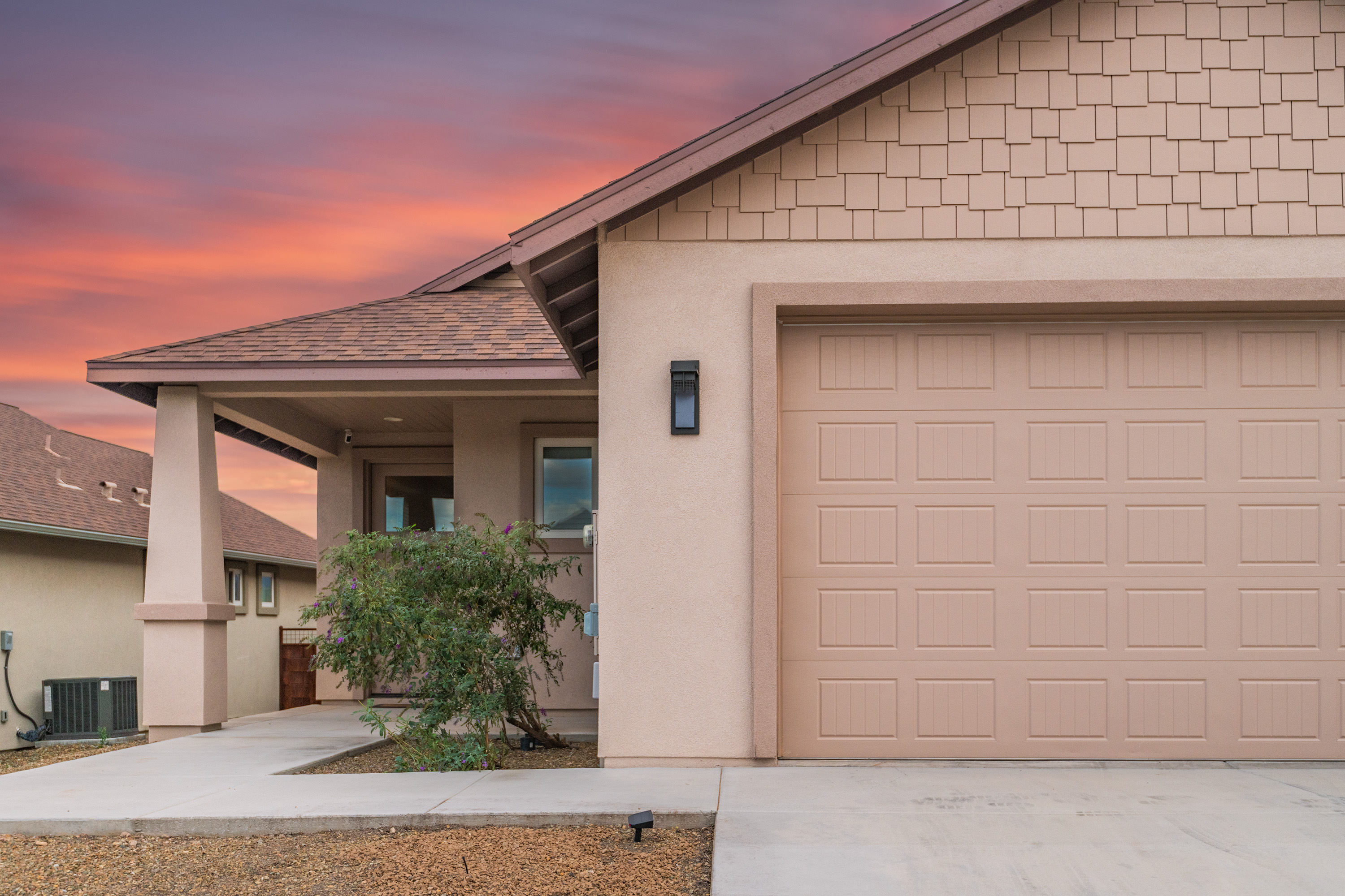 Welcoming modern exterior with garage and glowing sunset curb appeal