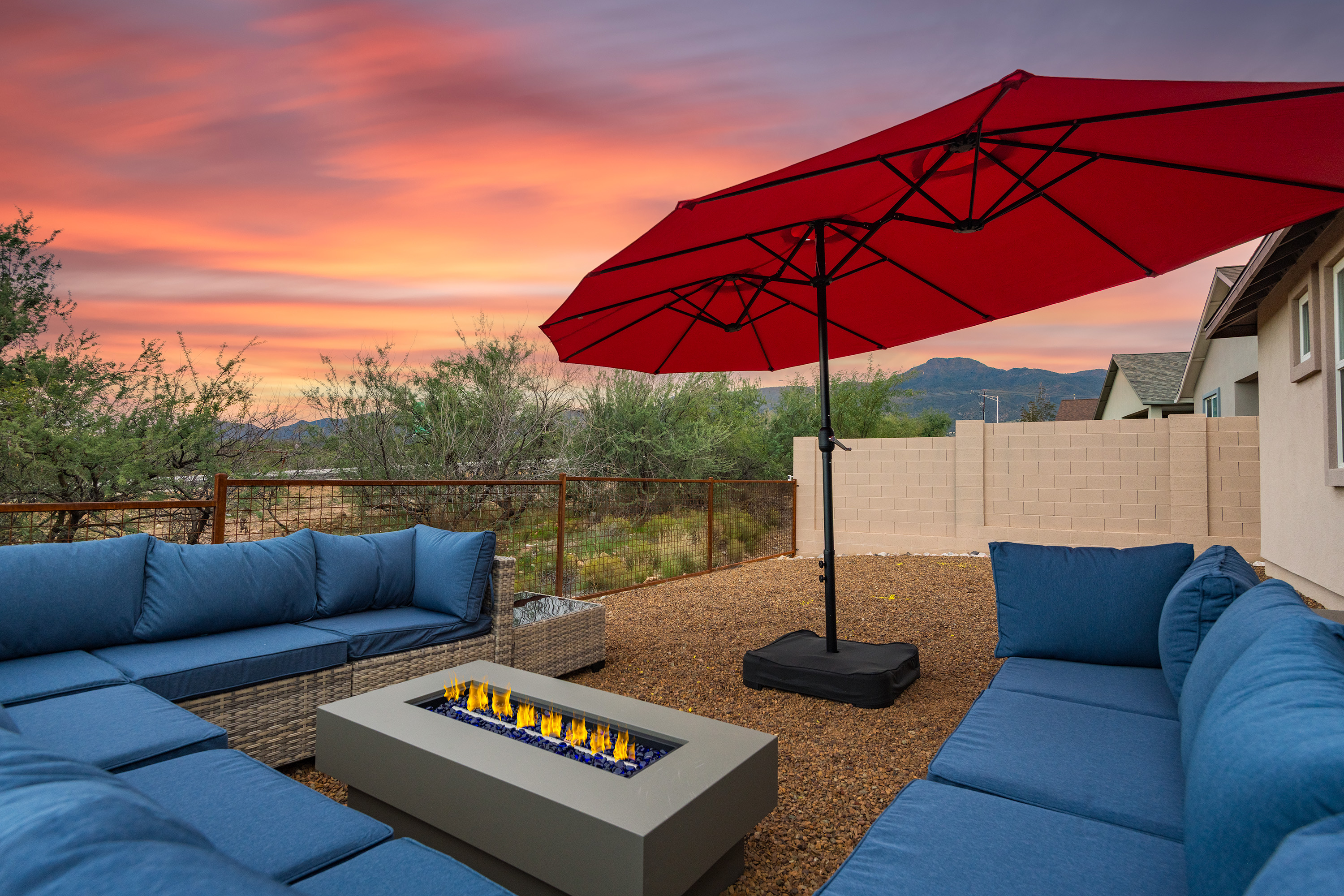 Sunset patio with fire table, plush seating, and scenic desert mountain views