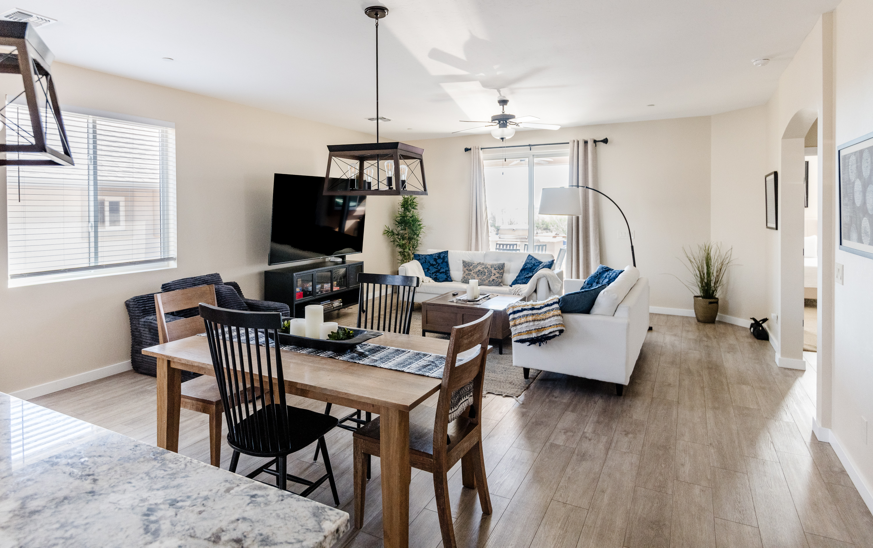 Bright open living space with cozy seating, dining area, and natural light