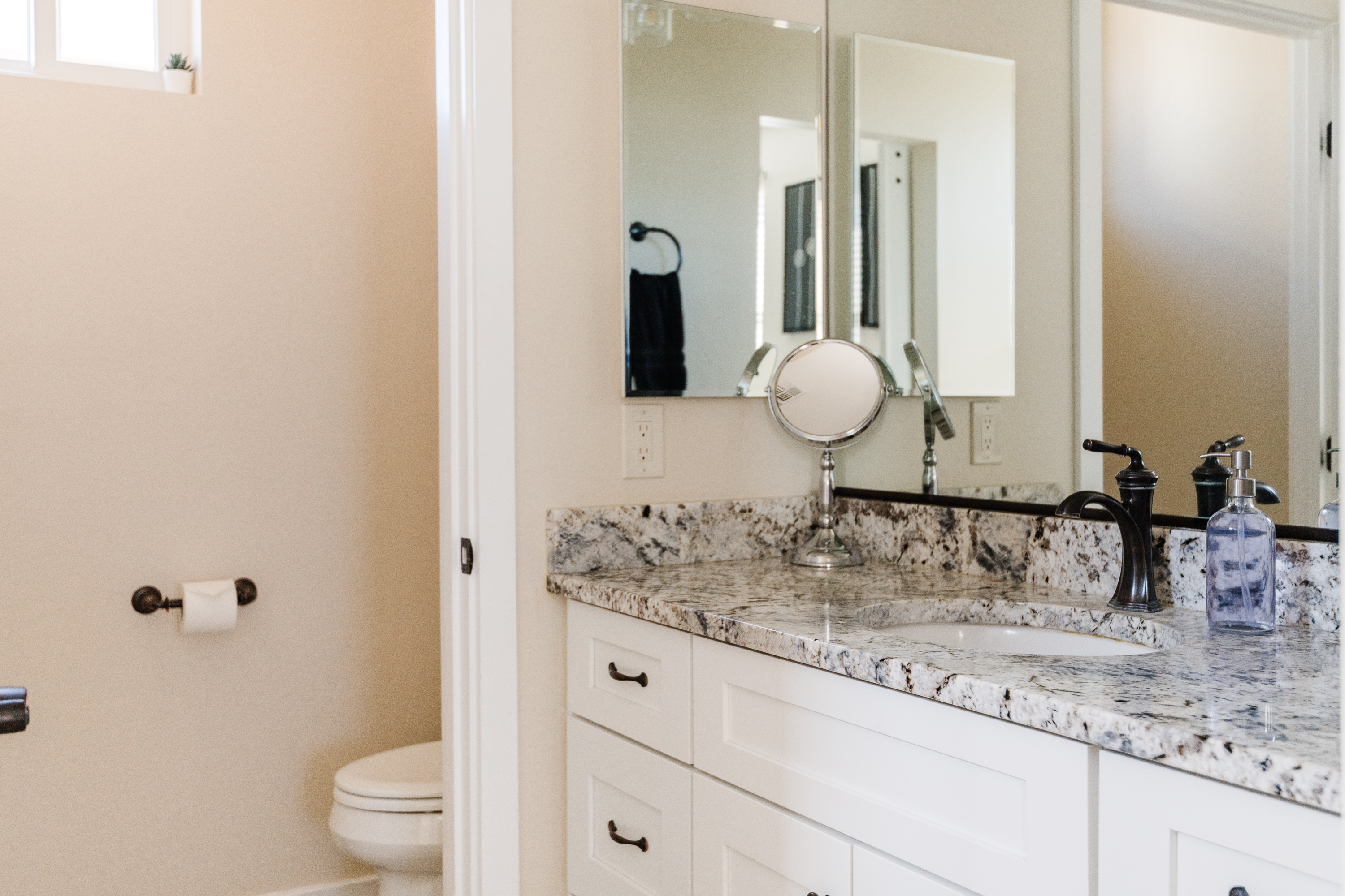 Bright modern bathroom with granite vanity and stylish finishes