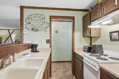 Cozy full kitchen with ample counter space and charming rustic details