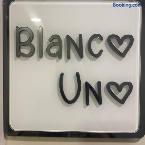Modern framed Blanco Uno sign with clean, stylish boutique flair