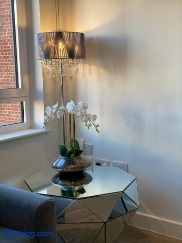 Elegant corner with mirrored table, orchid décor, and soft natural light