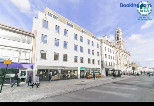 Modern city stay beside shops, cafes, and a landmark historic church