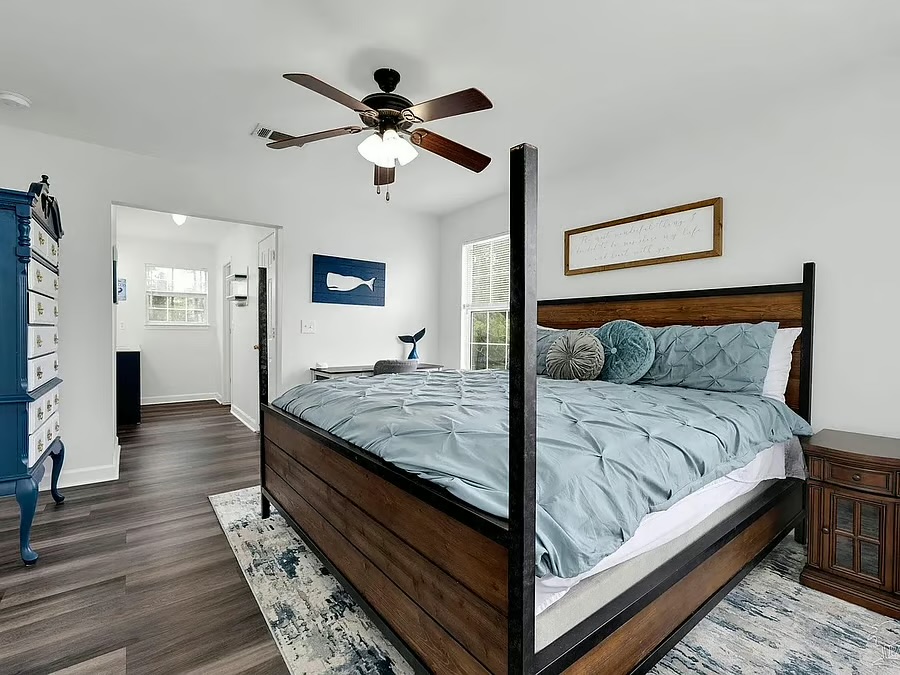 Bright, spacious bedroom with a stylish four-poster bed and calming decor