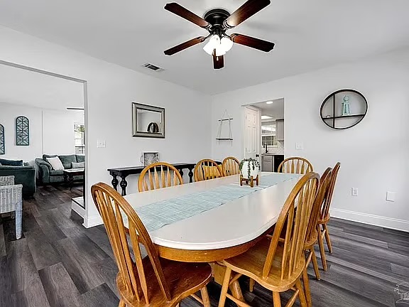 Bright dining room with seating for 8 and easy open-concept flow