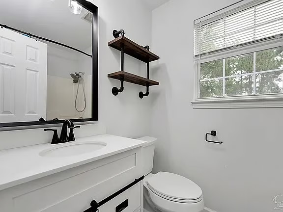 Bright modern bathroom with natural light and stylish open shelving