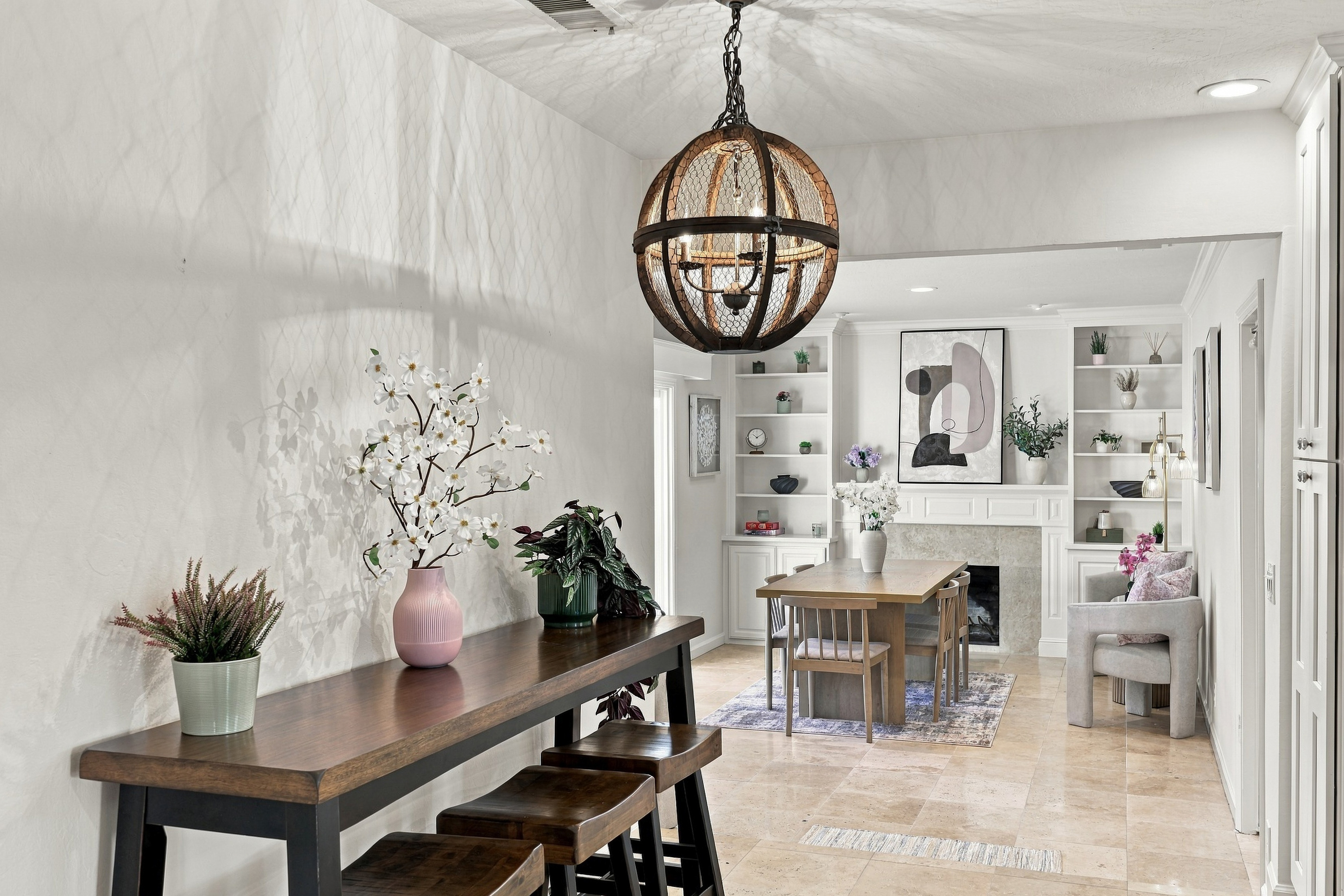 Bright, elegant dining nook with fireplace and designer touches