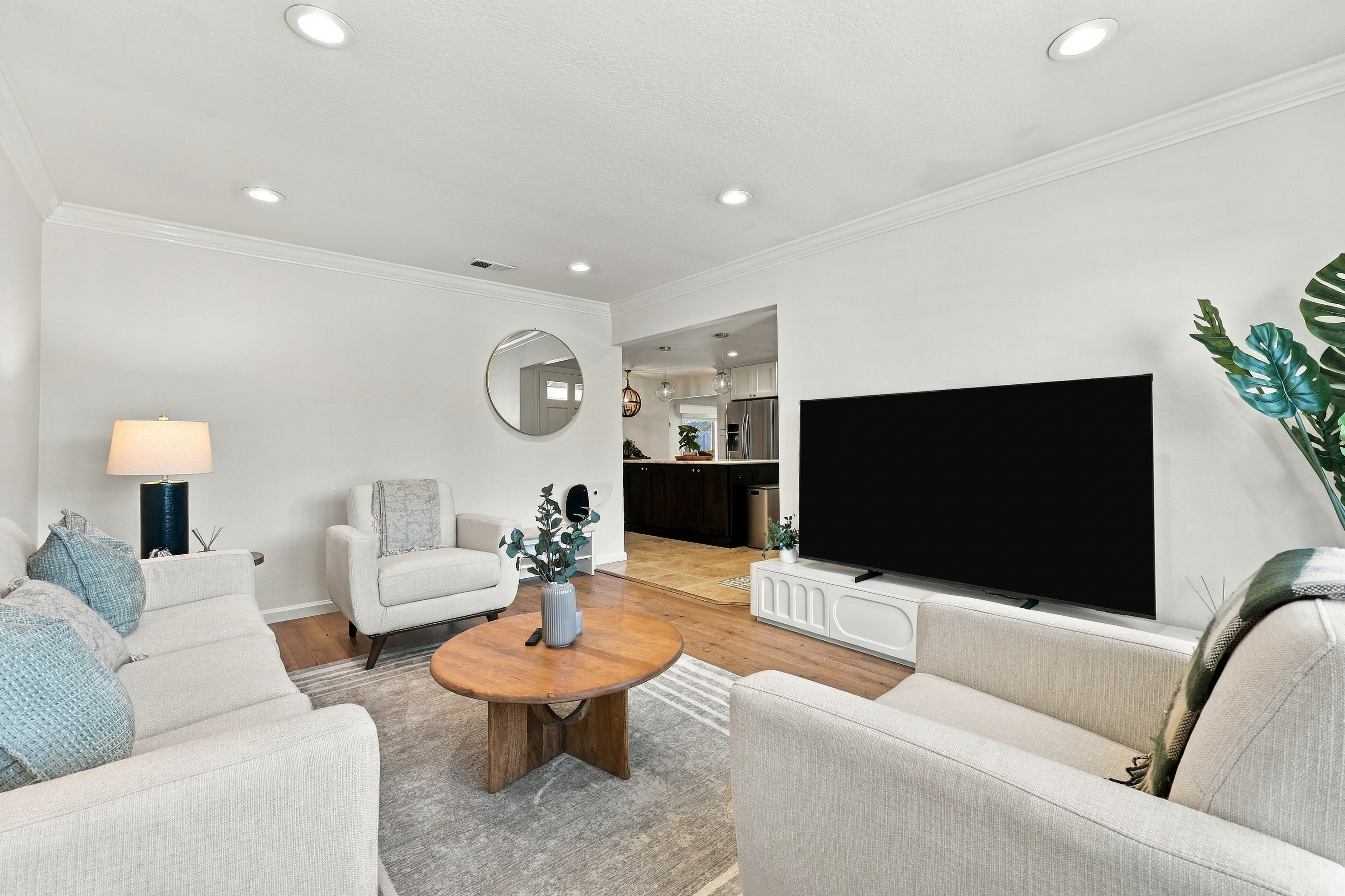 Bright, cozy living room with plush seating and a large TV