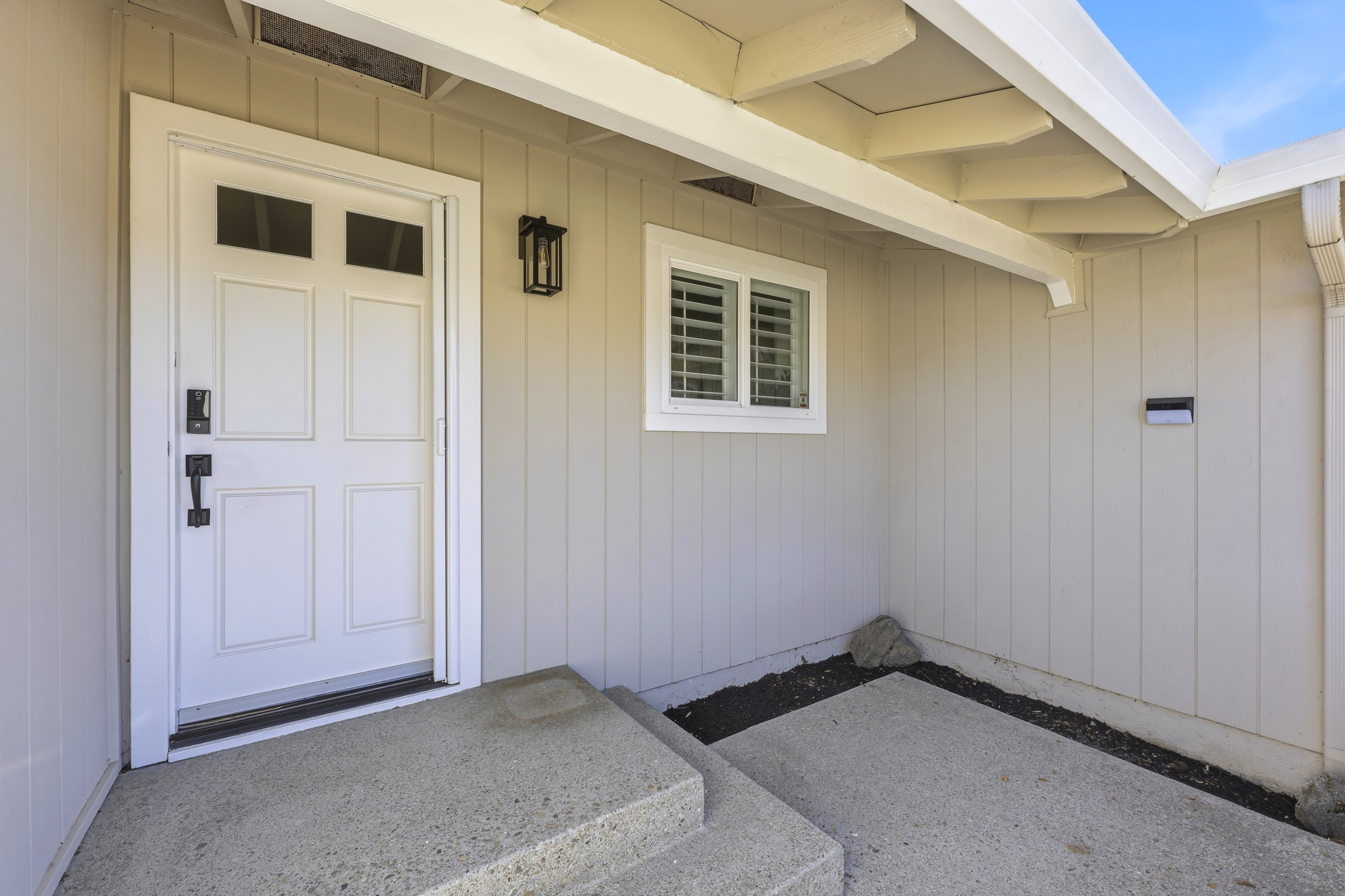 Welcoming covered entry with clean lines and charming curb appeal