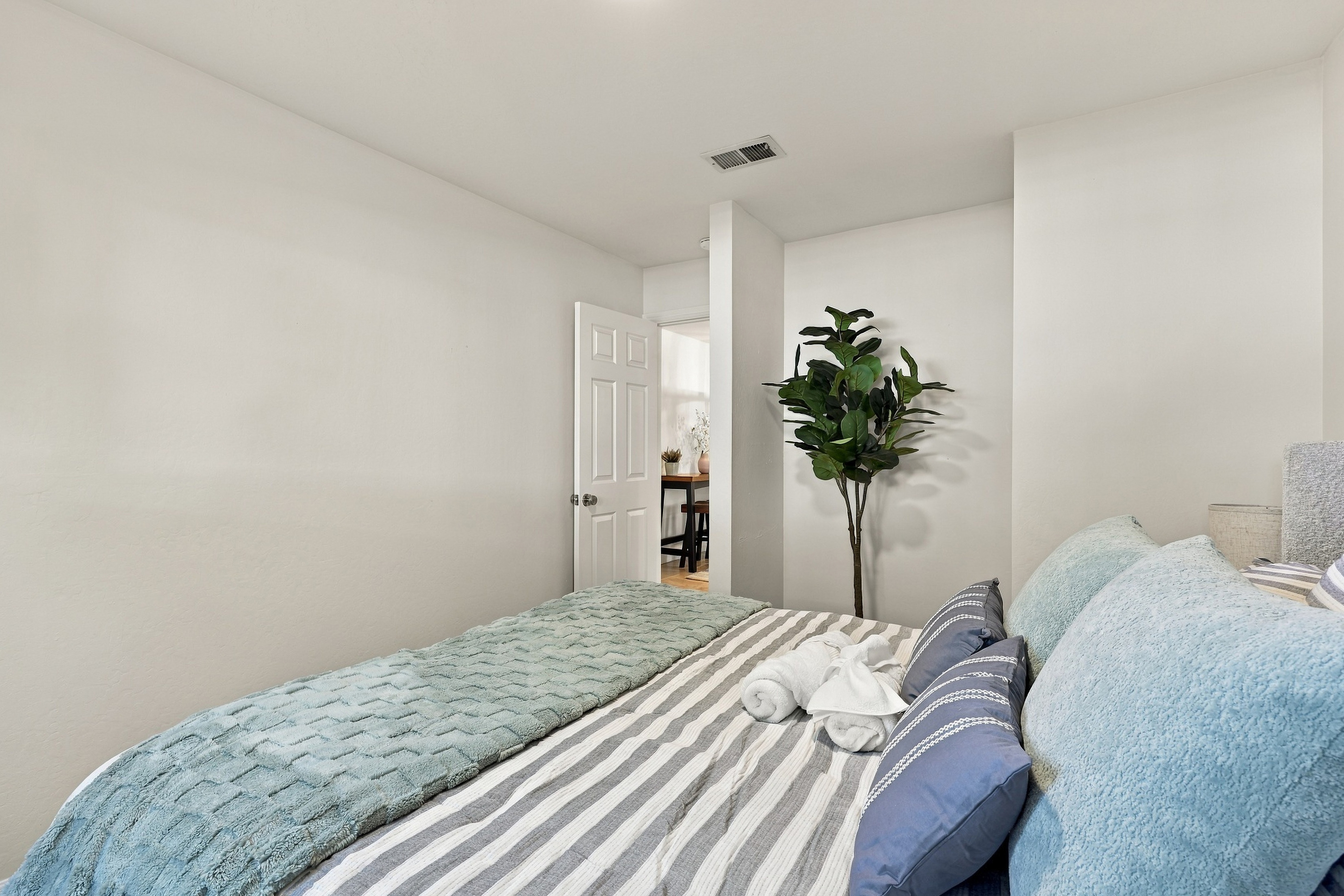 Bright, cozy bedroom with soft linens and a calm, relaxing vibe