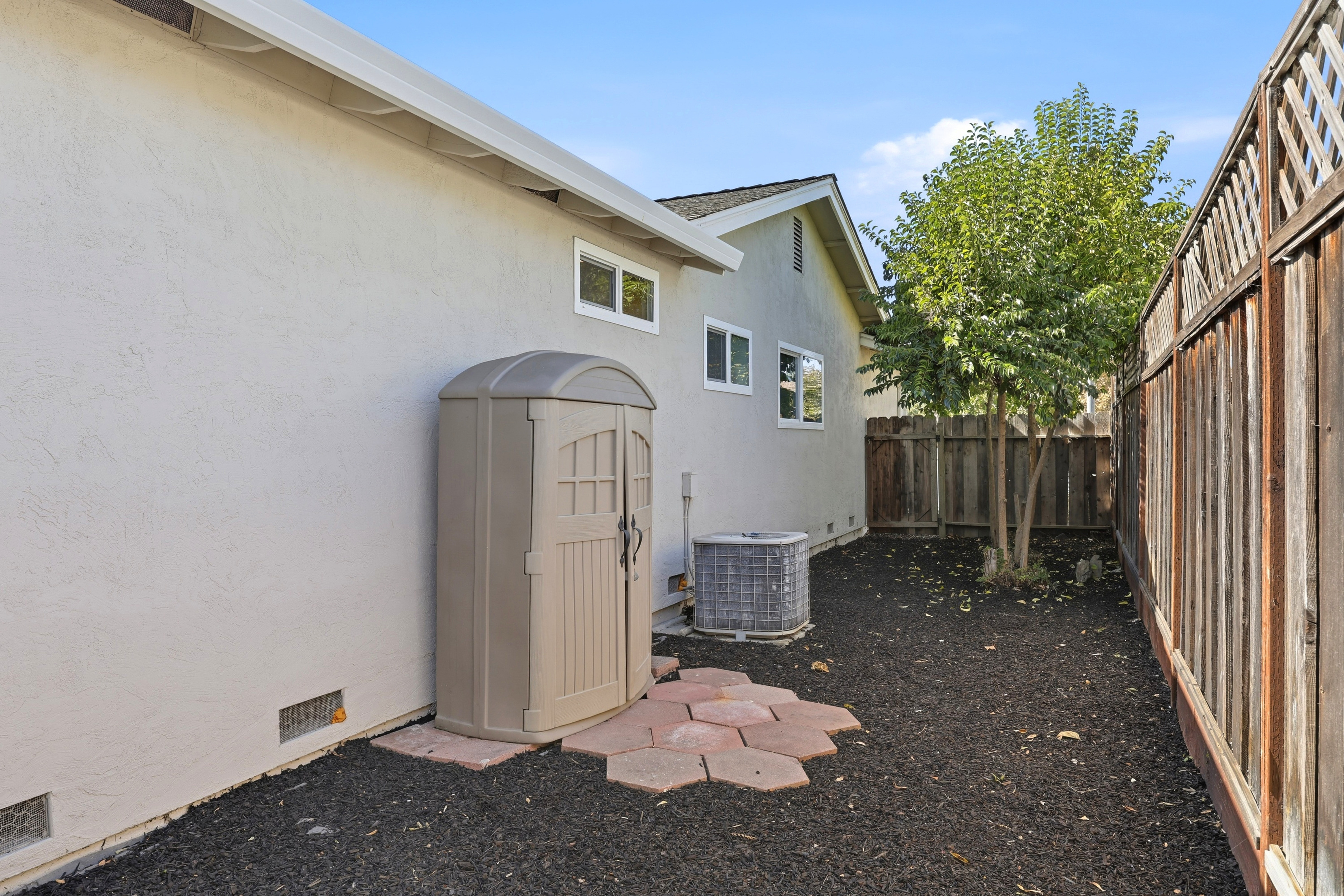 Private side yard with storage shed and low-maintenance outdoor space
