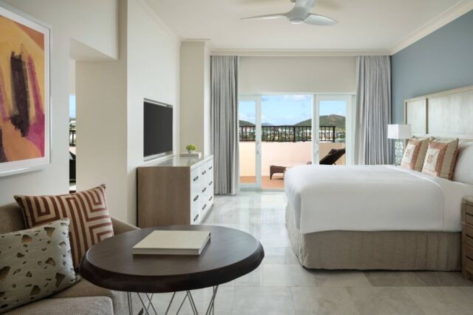 Spacious king suite with private balcony and relaxing outdoor views