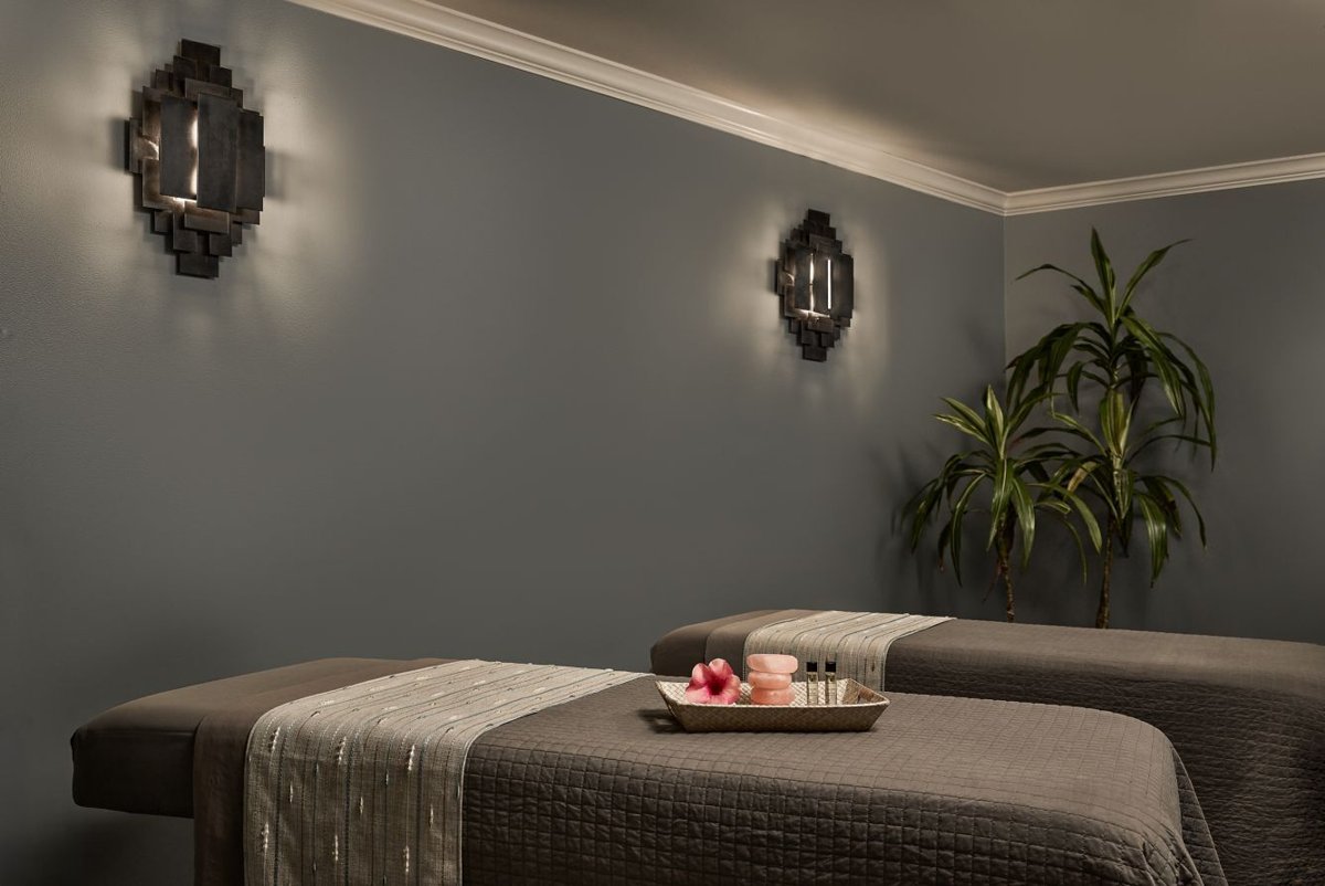 Tranquil spa room with dual massage tables and soothing ambient lighting
