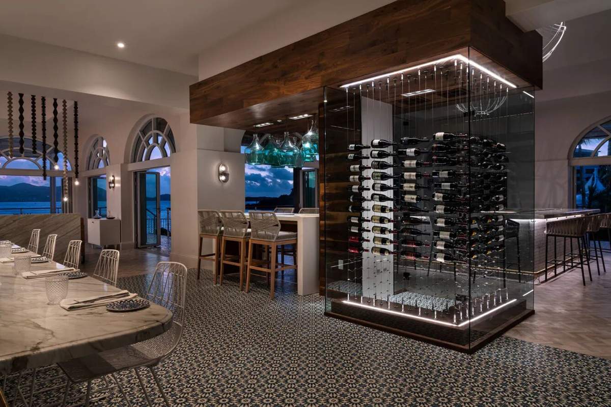 Stylish dining space with showpiece wine cellar and stunning water views