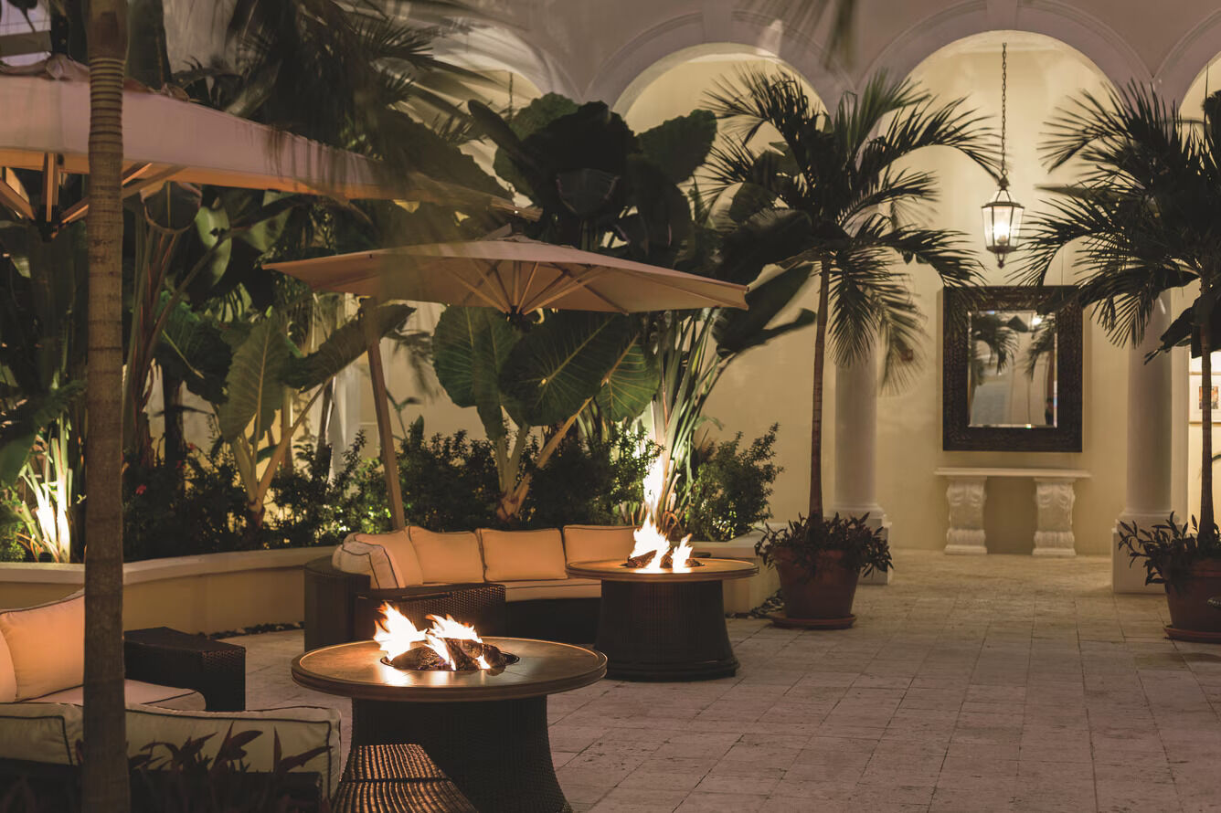 Elegant tropical courtyard with cozy fire pits and lounge seating
