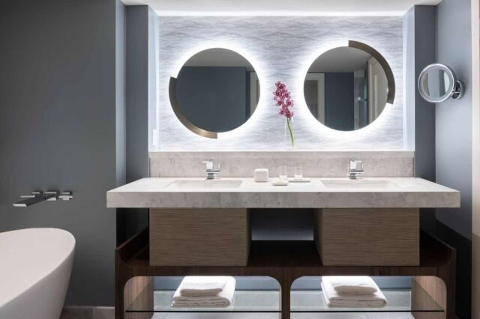 Spa-like double vanity with glowing mirrors and modern luxury