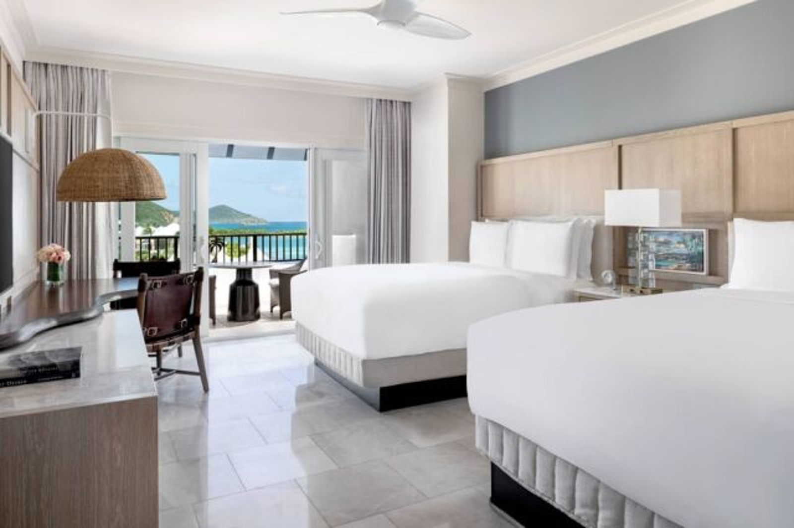 Bright double-queen room with private balcony and beautiful ocean views