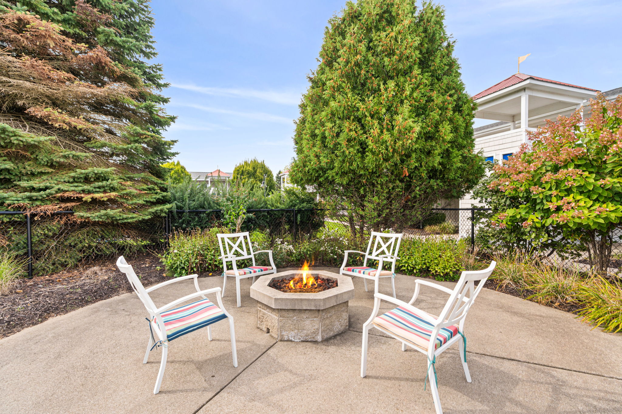 Cozy outdoor fire pit patio with seating in a private garden setting