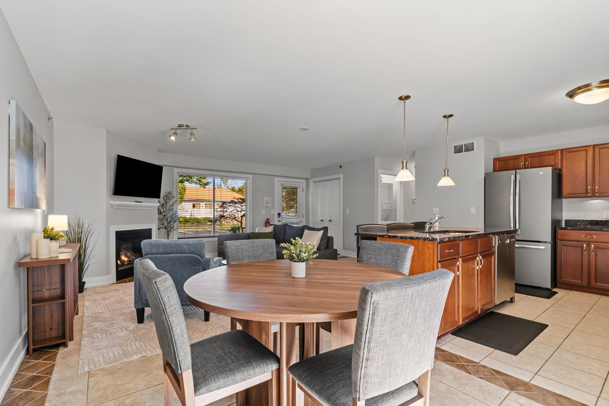 Bright open living space with fireplace, dining for 6, and full kitchen