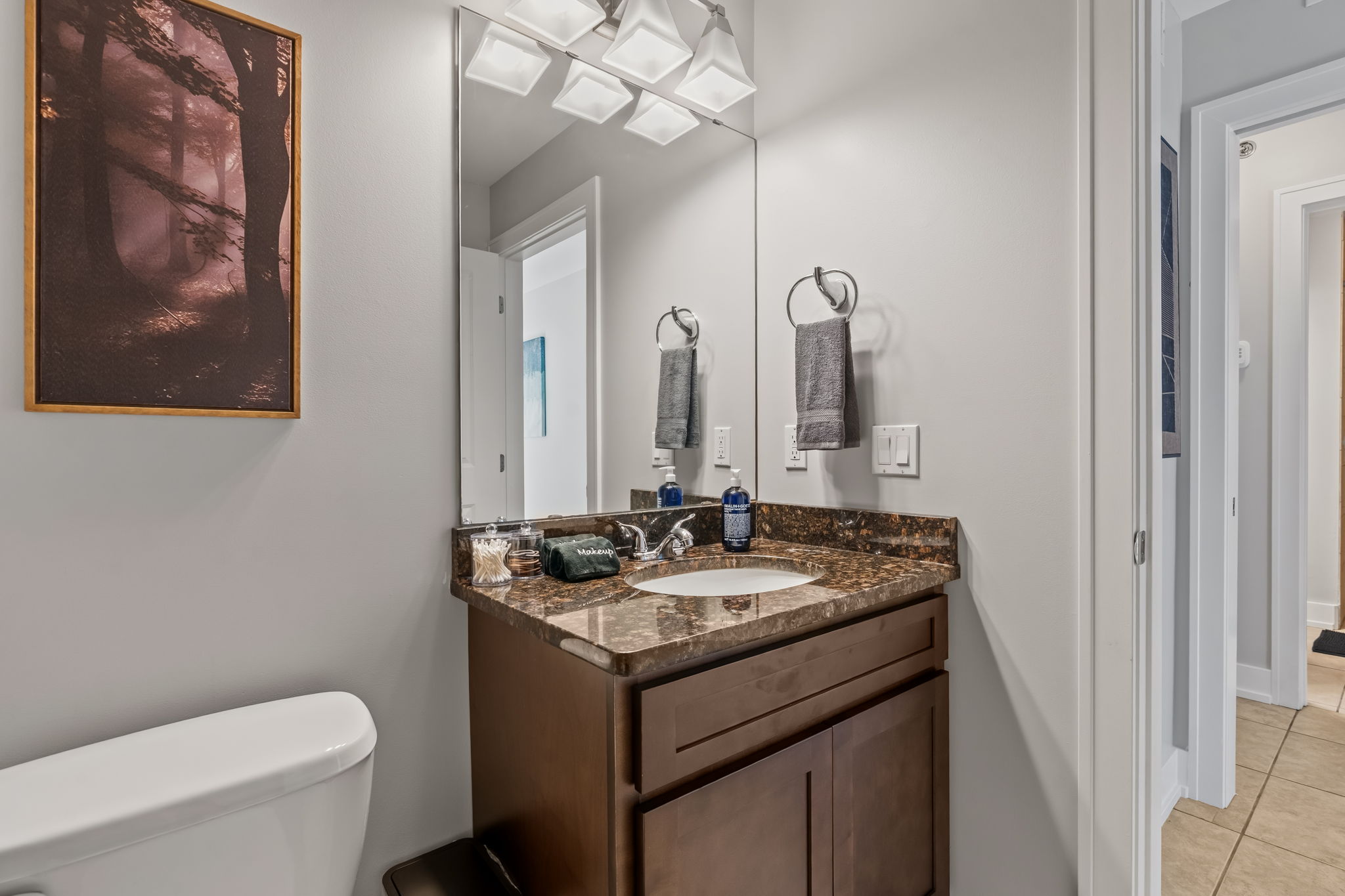Bright modern bathroom with granite vanity and stylish finishes