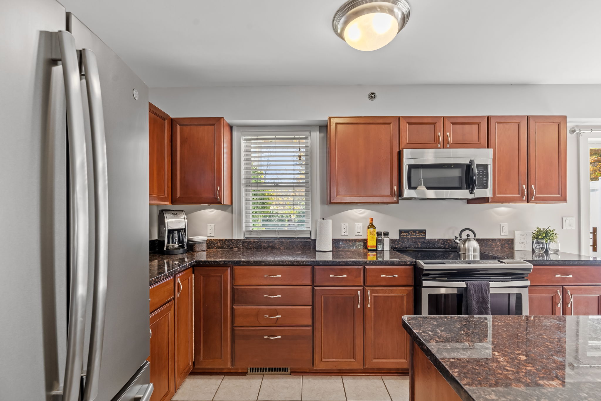 Bright kitchen with island, stainless appliances, and ample counter space