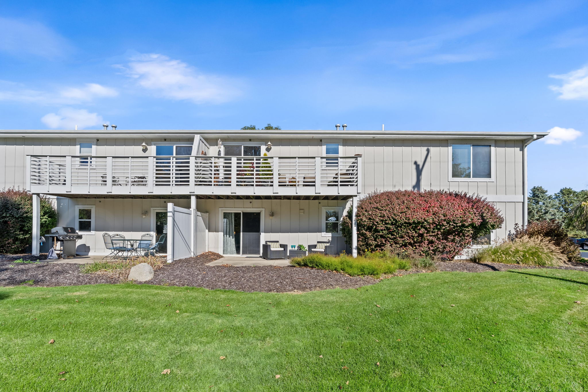 Spacious deck, patio, and expansive lawn for easy outdoor living